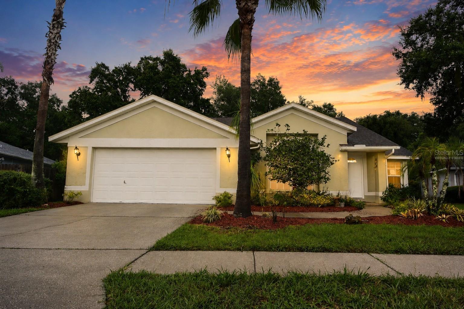 Virtually Staged. Opportunity awaits in the beautiful Twin Lakes community of Land O' Lakes! This 3-bedroom, 2-bath, 2-car garage home is perfectly situated on a scenic conservation homesite, offering peaceful views and exceptional privacy. Step outside to a gorgeous brick paver patio surrounded by lush tropical landscaping and mature grapevines, creating the perfect setting to relax and enjoy the natural surroundings. Inside, you'll find soaring ceilings, a formal living and dining room combination, a galley-style kitchen, an inside utility room, and a spacious family room with triple sliding glass doors that showcase the beautiful conservation views. The oversized primary suite also overlooks the conservation area and features a garden tub, separate shower, and generous closet space. A desirable split-bedroom floor plan and oversized two-car garage add to the home's appeal. Conveniently located just minutes from the Tampa Premium Outlets, State Road 56, I-75, shopping, dining, and an easy commute to Tampa's employment centers, sporting events, and entertainment. The home does need some updating, making it an outstanding opportunity to add your own personal style and build equity. Don't miss your chance—schedule your private showing today before it's gone!