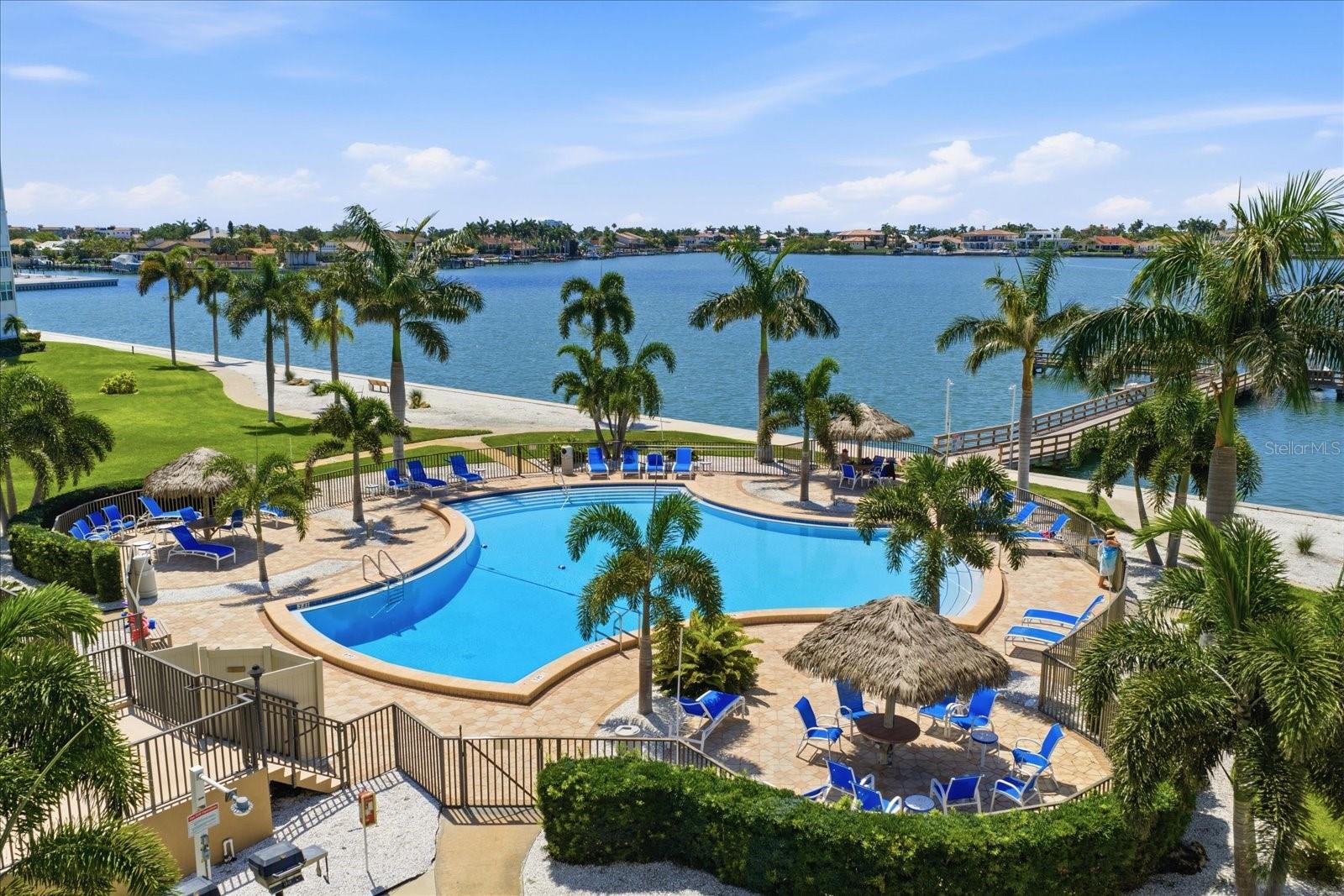 Tropical island setting and expansive water views are yours to enjoy from this spacious furnished 1,605 Sq Foot Point Brittany condo. Covered Parking space #32 is steps away from the building entryway. There is an exterior storage room and laundry included in your amenities. You will take notice of the pride of ownership and appreciate the flowing floorplan. Spectacular WATER VIEWS from your spacious 14x26 Living/dining area, 14x14 Family Room, 14x7 Sun Room, 14x24 Master and 13x15 2nd Bedroom! Point Brittany has it all! Point Brittany offers a myriad of amenities to accommodate a wide range of interests. The 55+ community boasts four heated swimming pools, a jacuzzi/hot tub, four HAR-TRU tennis courts lighted for night play, pickleball and shuffleboard courts and a waterfront Pavilion picnic and event area with a fire pit. A walkway path hugs the serene waterfront where a kayak storage area and launching dock, a fishing pier and deep-water boat docks can be found. The Point Brittany Residents Club is a hub of activity featuring a state-of-the-art fitness facility, saunas, a billiard room, a library, the elegant Ballroom and multiple additional activity rooms. At Point Brittany, a busy schedule is planned for community wide, festive, social and culinary events as well as regularly scheduled activity groups to tempt any interest. These include yoga, a variety of exercise classes, card and other games groups, a book discussion group, art and writing classes and much more. Within the grounds is a family-owned medical office with a GP, nurse, physical therapist, and podiatrist, as well as a beauty salon for your convenience. Adjacent to the property is the Bayway Country Store and Butcher Shoppe offering meat, seafood, premade fare: sandwiches, seafood dips, salads, soups, smoked fish and more…people drive miles for their products! Just minutes to St. Pete Beach, Ft. DeSoto Park, Downtown St. Pete, shopping, restaurants and interstate 275.