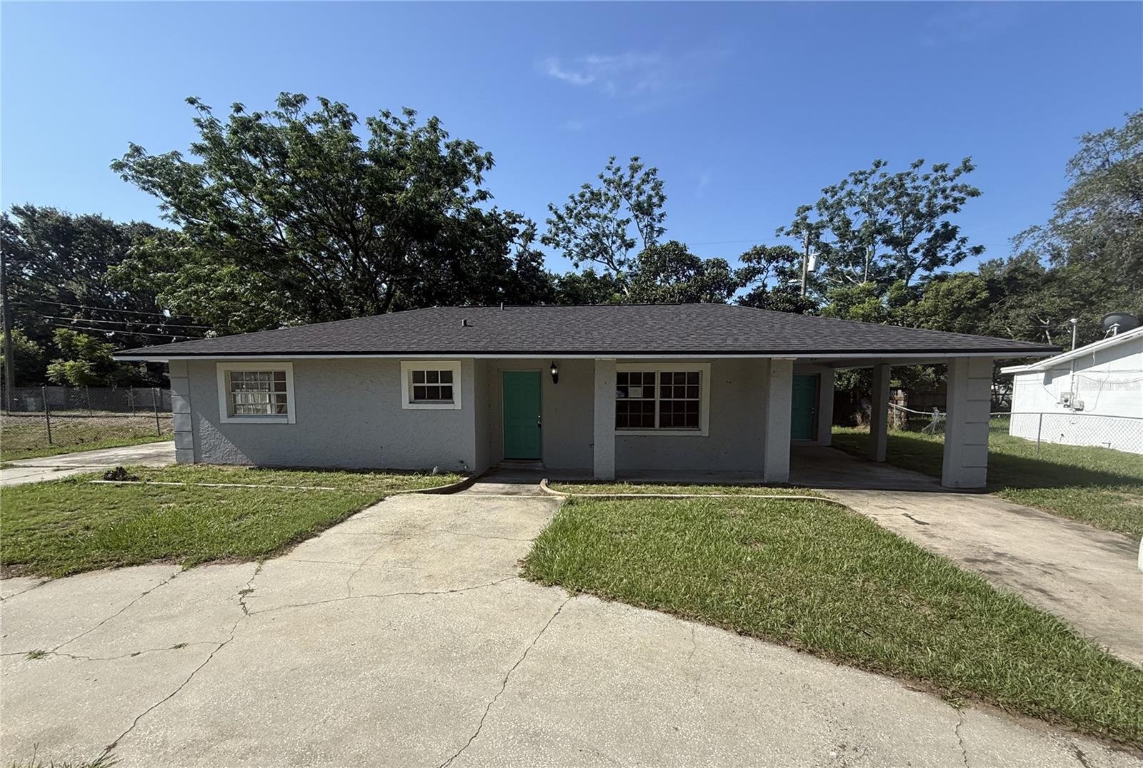 Established neighborhood in Lake Wales with the freedom of NO HOA or CDD. This block home is a clean slate and ready for you to come in and make it your own. With 1027 square feet, 3 bedrooms, 1.5 bathroom and carport - you have all the space you need. The open concept floorplan brings you from the front door into the living room. Kitchen is right off of the living room and includes ample cabinet and counter space, east in area, views of the wooded backyard and has a very spacious utility area attached with laundry room. The primary suite and guest bedrooms are just off the living room. Primary includes closet and convenient half bathroom. The secondary bedrooms share a full bathroom. Centrally located, close to the interstate, shopping and restaurants. It's good to be home. This property may qualify for Seller Financing (Vendee).
