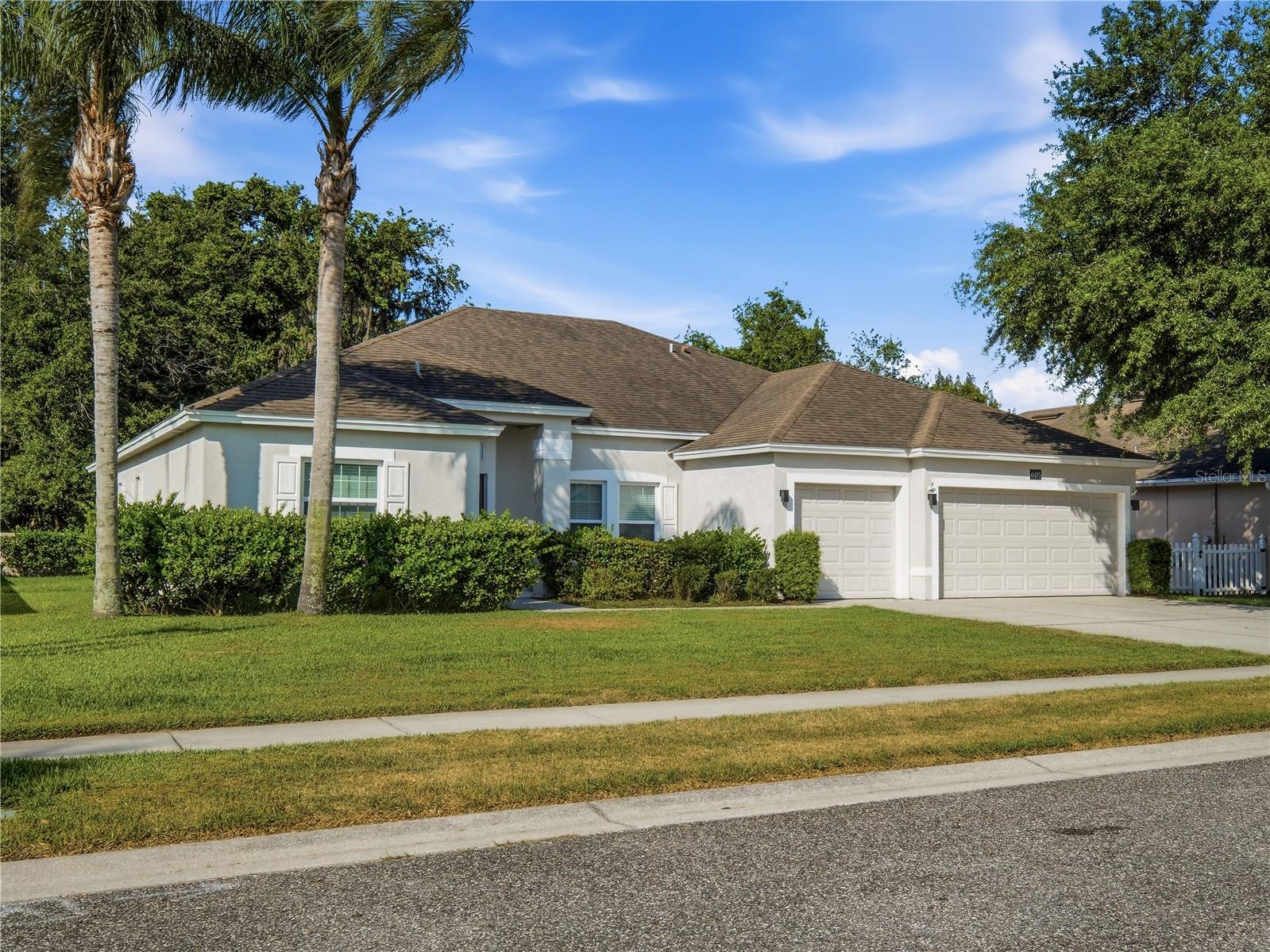 First time on the market for this beautiful four-bedroom, two-bath home in Sugar Mill Gardens! This split floor plan home offers comfort, luxury, and functionality—situated on a large lot with the backyard overlooking trees and nature in the preservation area. Inside, you will find an open layout with soaring ceilings, tile floors and a large living and dining area. The expansive kitchen is amazing, featuring white 42-inch cabinetry, granite countertops, tile backsplash, stainless steel appliances and a breakfast bar for extra seating. The kitchen overlooks the family room, a perfect space for friends, family and entertainment. You also have a breakfast nook that overlooks the backyard, perfect for your morning cup of coffee. The sizeable primary suite has a sitting area with sliding glass doors to the back patio and two walk-in closets. The primary bath includes double vanities, a garden tub and an oversized walk-in shower. The interior laundry room has plenty of room for storage.  There’s plenty of room for a golf cart and 2 cars in the three-car garage!  Sugar Mill Gardens includes private golf cart access to Sugar Mill Golf & Country Club – additional membership provides access to dining, golf, pickleball, tennis and a community pool. What a great location near I95, shopping, dining, groceries and the BEACH!