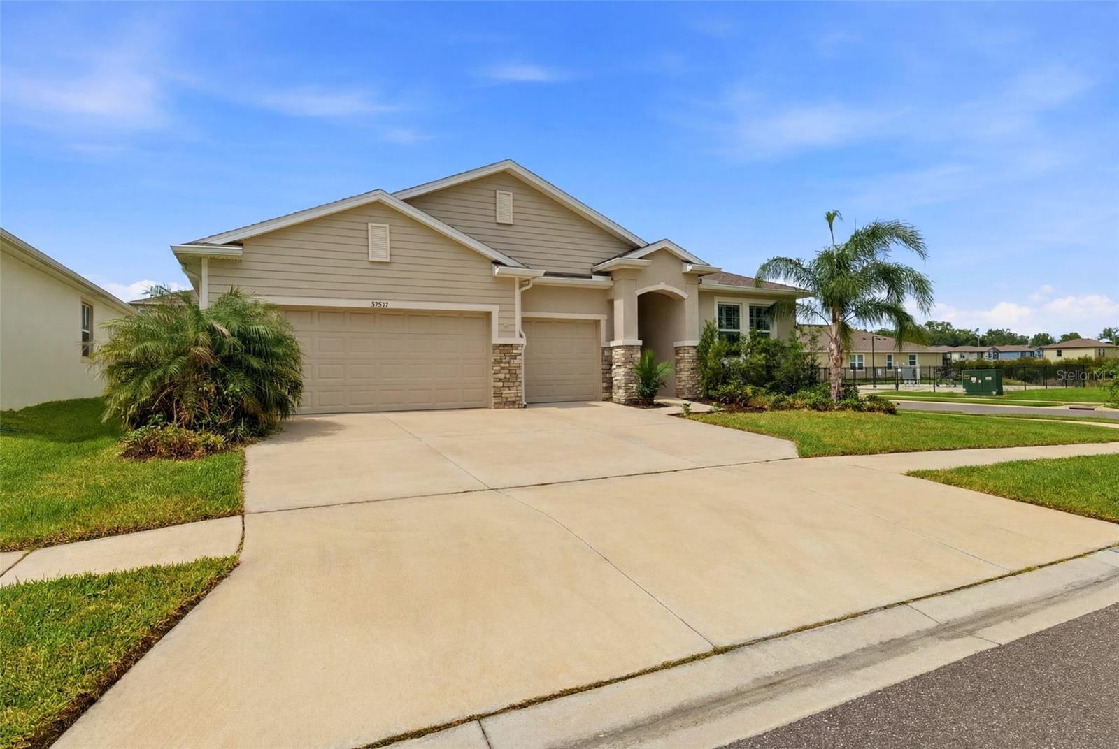 Situated on a premium corner lot in the heart of the highly sought-after Epperson Lagoon community, this rare Camden model offers the ultimate in flexible living, including a true multigenerational suite.
Welcome to resort-style living at its finest. This stunning home offers 4 bedrooms, 4 bathrooms, a 3-car garage and approximately 2800sq ft of beautifully designed single-story living that checks every box. From the moment you step inside, this home makes a statement. A generous foyer welcomes you with soaring ceilings, gleaming tile floors, and an immediate sense of space and light. The corner lot, additional windows and open-concept layout flow naturally, delivering the kind of bright, airy feeling that makes every day feel effortless.
This model’s standout feature is its fully equipped multigenerational suite, complete with its own private kitchen, a generous sized bedroom with its own full ensuite bathroom.
A full independent unit within the home means complete independence for extended family, in-laws, or guests, without ever compromising on comfort or privacy. The multi-gen layout offers separation and independence without leaving home. 
Two additional bedrooms share a jack-and-jill full bathroom at the front of the home, while the primary owner’s suite sits privately at the rear, offering beautiful backyard views. Master Ensuite has a double vanity, separate shower and tub and a large walk-in closet. 
The main chef’s kitchen flows seamlessly into a spacious great room with a formal dining room and dinette, all overlooking a covered lanai perfect for extending entertaining outdoors. HOA includes lagoon access and cable tv.
All of this within Epperson, home to the incredible 7.5-acre Crystal Lagoon with a swim-up bar, water slide, kayaking, paddleboarding, and private cabanas.  The community also features a 5-acre dog park, playground, Zen garden, and community Wi-Fi hotspots.  
Residents can also enjoy access to the second lagoon at a nominal per-day fee. 
Ideally located with easy access to top-rated schools, major highways, healthcare, shopping, close to the new Publix, and the largest Target in the country, plus with so many dining and entertainment options, everything you need is within reach. 
This is more than a home, it’s a lifestyle built for the way families actually live today. Don’t miss this rare opportunity to own this beautiful property with space for everyone you love, and a lifestyle that feels like a permanent vacation. Book your showing today!
