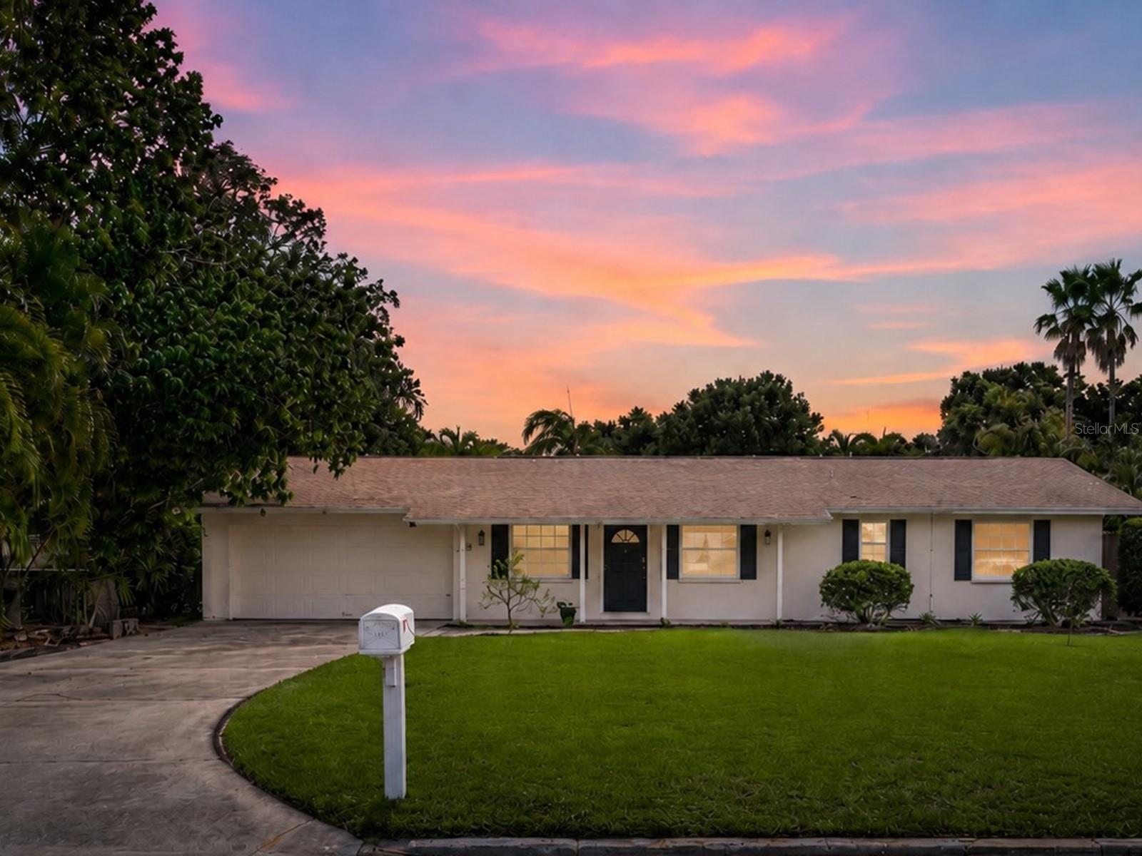 Welcome to 5927 Driftwood Ave., Sarasota, FL 34231—a classic Florida ranch home nestled in a desirable “West of Trail” community, just one block from the Intracoastal Waterway. Set on over a quarter of an acre, this Sarasota property offers a rare combination of timeless charm and modern updates in a location central to Siesta Key’s world-famous beaches, Phillippi Estate Park, and all the shopping, dining, and entertainment Sarasota is known for. The curb appeal stands out with a covered front porch and a welcoming Florida feel. Inside, the great room features open living and dining spaces with tile floors, a chandelier with ceiling medallion, and a crown-molding accent wall. Sliding doors connect the living area to a bright home office, offering an ideal setting for relaxation or entertaining. The kitchen is designed for both style and function, featuring custom white cabinetry with generous storage, gold hardware and fixtures, gold-veined white countertops, and a dedicated coffee station. A gas range is exciting for anyone who loves to cook, and the laundry is conveniently located just off the kitchen. Enjoy an apron sink, custom floor-to-ceiling pantry, stainless steel appliances, and a peninsula bar with drop lighting. There is also direct entry to the attached two-car garage with attic storage. Out back, your private backyard oasis awaits—surrounded by palm trees and privacy fencing. The heated open-air pool and covered lounge area—equipped with double ceiling fans—create a true Sarasota retreat for dining, relaxing, or entertaining. The pool bath features artisan blue scalloped tile, a walk-in shower with dual rainfall heads, a vessel sink atop a white shaker vanity with gold fixtures, and a sculptured mirror, all in an airy, light-filled palette. Both bedrooms offer wood-tone flooring, ceiling fans, and customized closet storage. The primary suite includes a walk-in closet and a recently updated en suite bathroom with a glass-enclosed, walk-in shower and marble-topped vanity. The second bedroom features mirrored closet doors and built-in organizer shelving. Additional storage is available in the hallway closet and attic. Practical features include partially updated windows and a propane tank. With no HOA restrictions at 5927 Driftwood Ave., you’ll enjoy the flexibility to bring your boat, RV, or other recreational vehicles—offering convenience for a variety of interests. Updates have already been started, allowing for your own finishing touches over time. Built in 1969, this home reflects the enduring craftsmanship of its era while providing endless opportunities for personalization. The unbeatable location, spacious lot, and flexible amenities make this Sarasota home a fantastic choice for those seeking a full-time residence or investment in a rapidly appreciating neighborhood. Experience the best of Sarasota living at 5927 Driftwood Ave.—just blocks from the Intracoastal Waterway, minutes to Siesta Key, and close to everything that makes Sarasota, Florida, such a desirable place to call home.