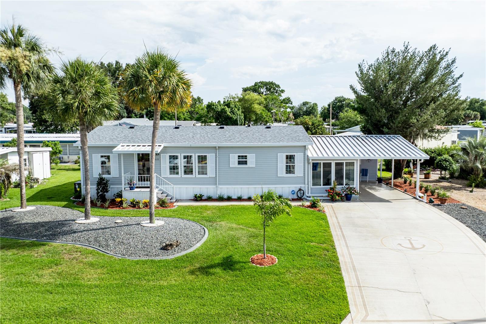 Welcome to 2611 Vindale Road — a beautifully updated home tucked inside one of Tavares' most beloved 55+ communities, where laid-back Florida living meets everything you need right at your doorstep. From the moment you walk in, it's clear this home has been thoughtfully refreshed from top to bottom and offers a thoughtful layout that serves both everyday comfort or is perfect for entertaining family and friends. The home features 2 bedrooms with an additional room that can be used as a 3rd bedroom, an office or den. Fresh interior paint sets a clean, welcoming tone, while luxury vinyl floors flow seamlessly throughout. New windows fill every room with natural light, creating a bright and airy feel. The kitchen is a true showstopper — completely reimagined with new cabinetry, gleaming granite countertops, and newer appliances (2023). Whether you're cooking for yourself or entertaining guests, this space delivers both style and function. The primary suite is spacious with an en-suite bathroom and offers a private standup shower. The enclosed Florida room has been finished and is fully heated and cooled, giving you a versatile bonus space to enjoy year-round. The laundry room is equally well-appointed, with the washer, dryer, and a small refrigerator all conveying with the home — just one more detail that makes moving in simple. Peace of mind comes built in: a new roof (2025), updated HVAC (2023), and new windows (2023) throughout mean the big-ticket items are already done. An existing termite policy is transferable to the new owner for a small fee, adding even more value and protection from day one. The shed stays, and some furniture is available for purchase — making for a truly effortless move-in experience. Step outside and you'll find lovely landscaping that gives the home wonderful curb appeal and a sense of pride of ownership. Conveniently situated close to the clubhouse and pool, the best of community living is just a short stroll away. All of this for a low $50/month HOA fee. The community is golf cart friendly and packed with activities — spend your days at the pool, clubhouse, shuffleboard courts, or out fishing. Boating enthusiasts will love the community marina and boat launch, offering direct access to the world-renowned Harris Chain of Lakes right from the neighborhood. Ideally situated right off Hwy 441, you're minutes from waterfront dining and entertainment, shopping, medical facilities, major attractions, parks, and airports. This is the one you've been waiting for.
