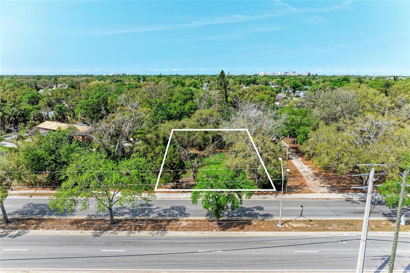 This oversized .38-acre homesite offers a rare opportunity to build a custom estate without the restrictions of an HOA in a highly sought-after Sarasota location just blocks from the unique culture and amenities of Pinecraft. Boasting 100 feet of frontage and a deep 165-foot lot, the property provides ample space for a high-specification residence, detached workshop, or expanded outdoor storage that smaller infill lots cannot accommodate. Because a home previously occupied the site, buyers may benefit from significant impact fee credits and existing utility access, providing a clear advantage for a streamlined building process. The OUE-2 zoning provides a unique level of flexibility for those seeking a private compound just minutes from the Legacy Trail, downtown Sarasota, and major transit corridors. This is an ideal foundation for a modern, hurricane-rated masterpiece in a transitioning area where property values continue to rise. Stop settling for cookie-cutter developments and tight quarters—bring your builder, secure your footprint, and own what’s real.