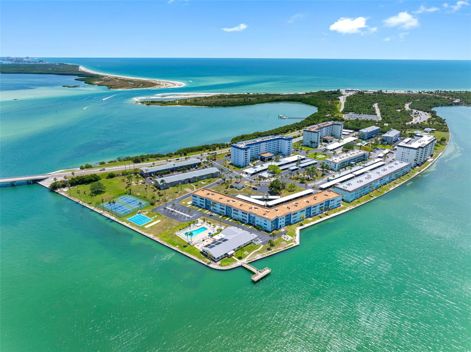 Coastal waterfront living with this beautifully renovated one-bedroom waterfront condominium in a desirable 55-plus community along the Dunedin Causeway, just moments from Honeymoon Island State Park and its award-winning beaches. Completely remodeled in 2026, this stunning residence offers stylish coastal living with quality finishes and thoughtful upgrades throughout. The designer kitchen features white shaker cabinetry, white with gold lightening quartz countertops, a dolomite marble backsplash, brushed gold fixtures, recessed lighting, crown molding and new stainless steel appliances. The beautifully updated bath showcases custom tile work with a striking accent wall, dolomite marble flooring, brushed gold faucets and a lighted medicine cabinet. Additional upgrades include new HVAC, plumbing, electrical, luxury vinyl flooring and custom Elfa closet systems. The all-season sunporch offers relaxing water views and the ideal setting for morning coffee or evening sunsets. Enjoy resort-style amenities including a heated waterfront pool, fishing pier, clubhouse, fire pit, gas grilling area, tennis, pickleball, bocce, shuffleboard, and an active social calendar with concerts, dances and community events. Watch dolphins along the seawall, enjoy the scenic two-mile Dunedin Causeway path or bike the nearby Pinellas Trail just over the causeway, offering miles of picturesque coastal riding and recreation. Charming downtown Dunedin is only minutes away and filled with fantastic restaurants, rooftop bars, breweries, boutique shopping, waterfront parks, live music and year-round events that make Dunedin one of Florida’s desirable coastal towns. HOA includes cable/internet, gas, water, sewer, trash, pest control, lawn care, pool maintenance, flood insurance and more. As a two-story building, SIRS and Milestone inspections do not apply. No-pet community, but ESAs permitted with proper documentation.