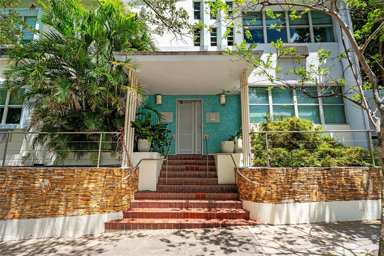 Set within the historic Lema building in Miramar, this one-story residence offers a rare combination of architectural character, privacy, and indoor-outdoor living in the heart of San Juan’s Arts District.

Originally built in 1954, the boutique building reflects subtle Art Deco influences and a scale rarely found in newer developments, with only two residences per floor and a quiet residential atmosphere surrounded by the energy of the city.
?
Inside, the home unfolds through a calm and curated layout where natural light, warm materials, and clean lines create a sense of openness without losing intimacy. Approximately 1,301 square feet of interior living space connect naturally to an expansive private terrace of nearly 700 square feet, blurring the boundary between indoors and outdoors.
?
Oversized glass openings extend the main living areas toward the terrace, creating a setting equally suited for quiet mornings, evening gatherings, or simply disconnecting within your own private environment.
?
At the center of the residence, an indoor pool introduces an unexpected layer of retreat and atmosphere rarely experienced in urban living. The surrounding terrace further expands the experience, bringing greenery, openness, and natural ventilation into the home.
?
The residence includes two bedrooms and one and a half bathrooms, along with flexible living areas that adapt naturally to daily routines, creative workspaces, or hosting. High ceilings, gallery-like walls, and travertine flooring reinforce the home’s architectural personality and connection to Miramar’s artistic character.
?
Additional features include a full backup generator, private storage, elevator access, and a two-car garage, supporting both comfort and practicality.
?
Located near hotels, theaters, restaurants, supermarkets, Distrito T-Mobile, and the Condado Lagoon area, the residence places you within one of San Juan’s most culturally layered and walkable neighborhoods.
?
A home that feels both grounded and transportive, offering privacy, design, and atmosphere within the center of the city.
