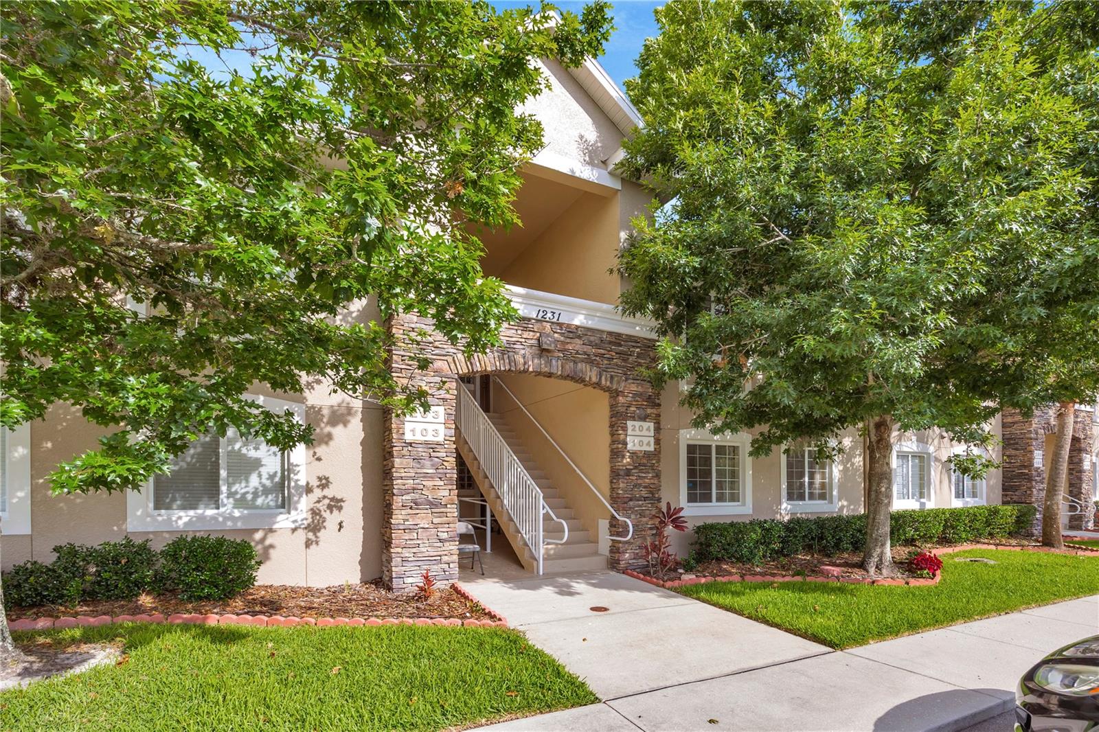 Welcome to Anand Vihar, Wesley Chapel's premier gated 55+ community, where luxury, convenience, and maintenance-free living come together in this never-lived-in, 3-bedroom, 2-bath Club Villa condominium.

Located on the second floor, this desirable split-bedroom floor plan offers a bright, open-concept design with upscale finishes throughout. The spacious kitchen serves as the heart of the home, featuring beautiful quartz countertops, 42-inch soft-close cabinetry, stainless steel GE Profile appliances, abundant workspace, and a breakfast bar that opens seamlessly to the living and dining areas—perfect for both everyday living and entertaining.

The owner's suite provides a peaceful retreat with dual walk-in closets and a luxurious en-suite bath featuring a large walk-in shower. Two additional guest bedrooms and a full bath offer comfort and privacy for family and visitors. Tile flooring throughout, crown molding details, upgraded finishes, and the convenience of being completely move-in ready make this home an exceptional opportunity.

Step outside to your private screened lanai and enjoy tranquil landscape views, or take a short stroll to the spectacular Anand Vihar clubhouse. Residents enjoy an unmatched resort-style lifestyle featuring a heated pool and spa, state-of-the-art fitness center, steam rooms, yoga and meditation spaces, movie theater, community gathering areas, and scenic walking trails throughout the beautifully maintained grounds.

One of Anand Vihar's most distinctive features is its on-site dining hall, where residents can enjoy freshly prepared meals featuring authentic vegetarian cuisine inspired by the diverse regions of India, creating a truly unique and convenient lifestyle experience.

The HOA fee provides exceptional value and includes cable, internet, exterior building maintenance, insurance, landscaping, irrigation, trash service, and access to all community amenities, allowing owners to enjoy a low-maintenance lifestyle with only water and electric expenses to manage.

Ideally located near The Shops at Wiregrass, Tampa Premium Outlets, The Grove, golf courses, restaurants, medical facilities, Flatwoods Preserve, and major highways including I-75, I-275, and I-4, this is a rare opportunity to own a pristine, move-in-ready home in one of Wesley Chapel's most distinctive and sought-after active adult communities.