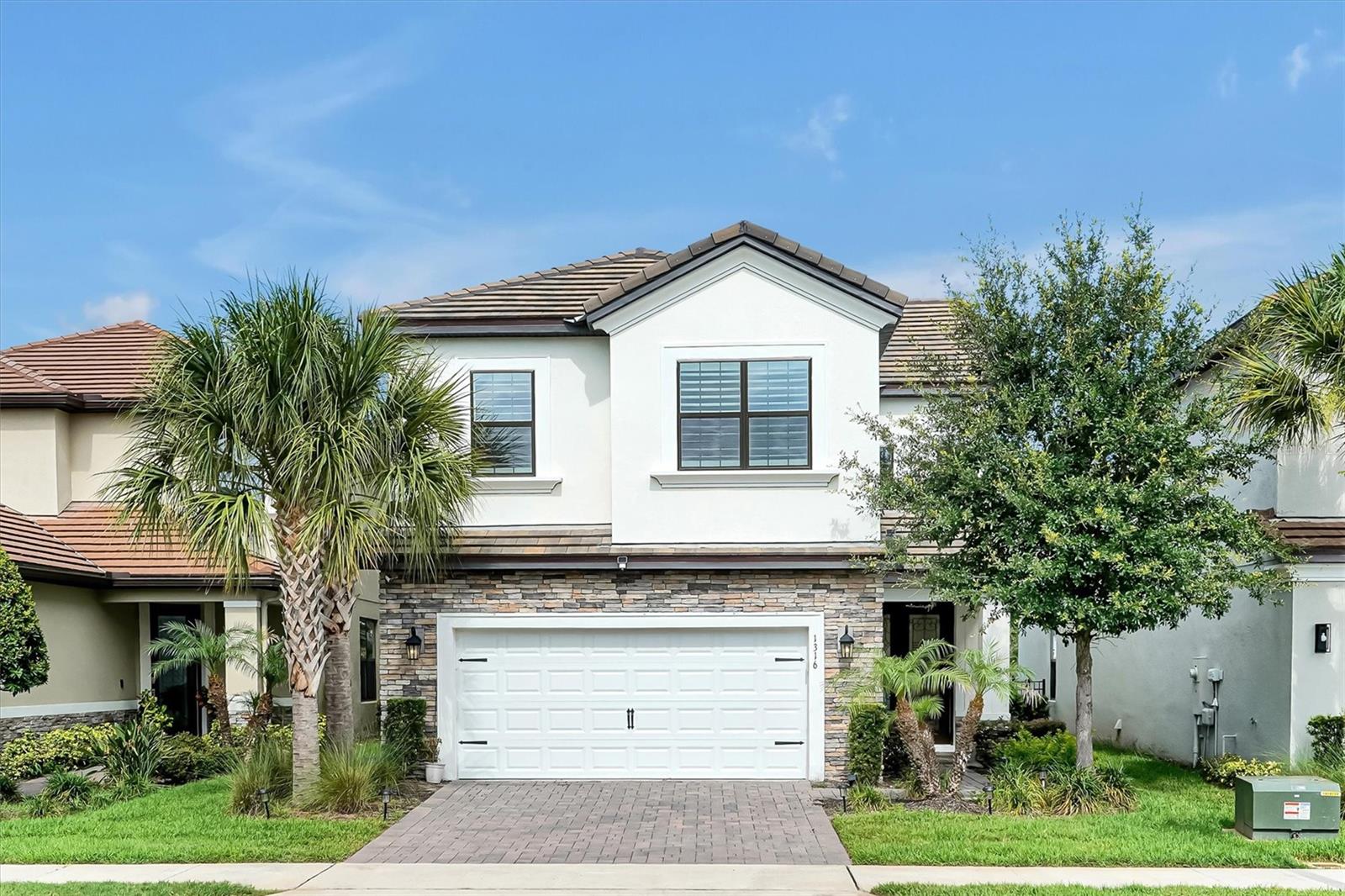 Welcome to this stunning Taylor Morrison Boca model in the highly desirable Hawks Crest gated community. This beautifully maintained 4-bedroom, 2.5-bath home offers an exceptional blend of luxury, comfort, and modern convenience.

Upon entry, you're greeted by a dramatic two-story foyer with soaring 20-foot ceilings and abundant natural light. The open-concept living spaces feature luxury vinyl plank flooring throughout, plantation shutters, and corner sliding glass doors that seamlessly connect indoor and outdoor living.

Enjoy breathtaking west-facing water views, a picturesque fountain and bridge backdrop, and spectacular sunset views from your private backyard. One of the home's standout features is its generously sized, aluminum-fenced backyard, offering ample space for outdoor entertaining, play, pets, gardening, or even a future pool while still enjoying tranquil waterfront views.

Thoughtful smart-home upgrades include electric curtains on the sliding doors, Eufy security cameras, smart door locks, and a MyQ-enabled garage door. The oversized two-car garage also features convenient touchpad access.

Residents of Hawks Crest enjoy resort-style amenities including a community pool, fitness center, clubhouse, playground, and scenic walking trails. Outdoor enthusiasts will appreciate direct access to Lake Howell for kayaking and canoeing. HOA dues include professional landscaping maintenance, allowing homeowners to enjoy a beautifully maintained property with less upkeep.

This move-in-ready home offers the perfect combination of elegant design, premium upgrades, abundant outdoor space, low-maintenance living, and an unbeatable waterfront lifestyle.