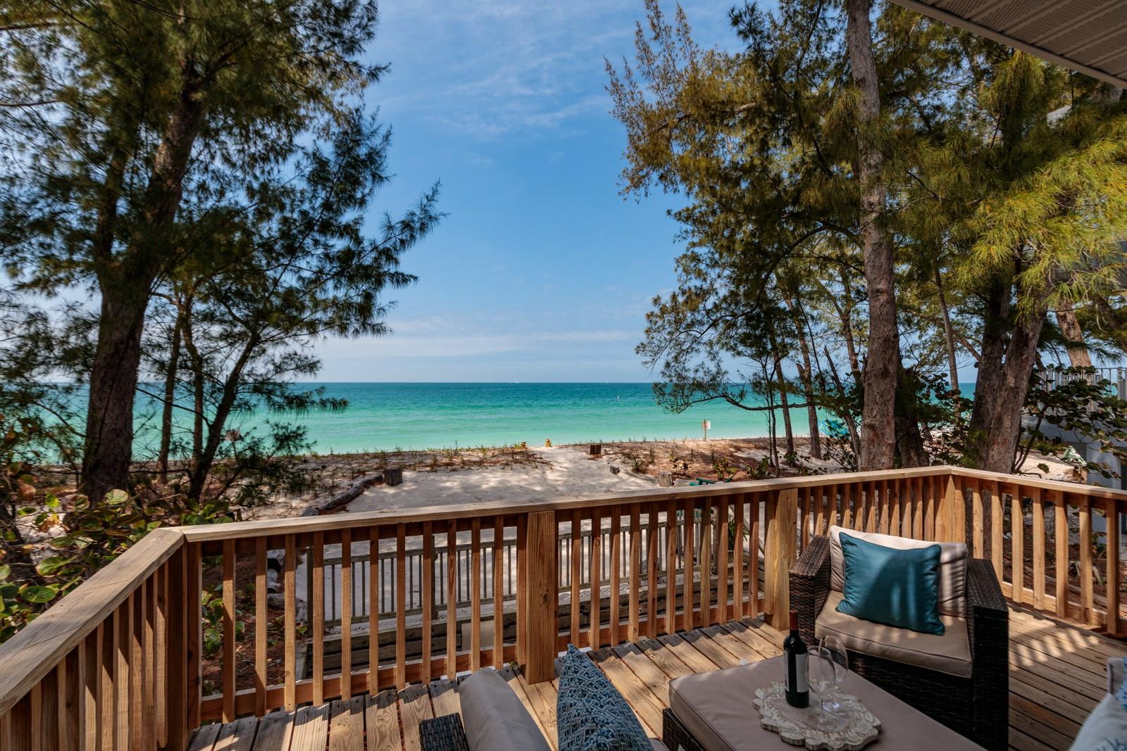 ~LIFE IS SHORT~BUY THE BEACH HOUSE~ This beachfront sanctuary sits on one of the most quintessentially perfect Old Florida shaded beach lots directly on Sunset Beach on the southern tip of Treasure Island. Hidden under the Australian pines on one of the quietest stretches of sand, you will fall in love with the daily post-card views over turquoise waters. Sunsets here are different hues of beauty every single day and the dolphins & seabirds will entertain you constantly. Perched on a spacious 50 ft beachfront lot, this elevated residence boasts a pristine expanse of new dunes and sea grass, creating a seamless transition from your doorstep to the sugar white sands.  The allure of the property is heightened by its thoughtfully designed layout featuring a stunning wood & glass stairway along with three generously sized bedrooms, each complimented by its own ensuite bathroom and a walk-in closet.  One of the gems of this coastal haven is the primary suite, a recent addition on the third floor completed in 2018.   From the open living- dining room ascend up the architecturally designed glass stairway to find an oversized owners retreat with a large walk-in closet that doubles as a private study.  The primary bathroom features a large step-in shower and separate soaking tub or you could sip drinks on your own private balcony.   Beyond the interiors, the allure of this special home extends to the outdoors where two expansive decks face the Gulf, inviting you to every sunset.  Ample storage including sheds ensures that beach gear finds its place effortlessly, while covered parking for four cars plus additional four spots in the driveway accommodates both residents and guests with ease. What truly set this home apart is its strategic positioning, six houses away from the nearest public parking and access points. Until you live on the beach, you may not appreciate the exquisite VALUE of this location as fewer visitors will set up in front of your home. The roof, plumbing and electrical systems have all been expertly updated ensuring not just comfort but also peace of mind.  With clean inspection report including 4point and wind mitigations, survey and elevation certificate, this beachfront retreat stands as not just a residence but an investment in a lifestyle. Please see floor plans and videos for more details and don't miss your opportunity to live in Paradise.