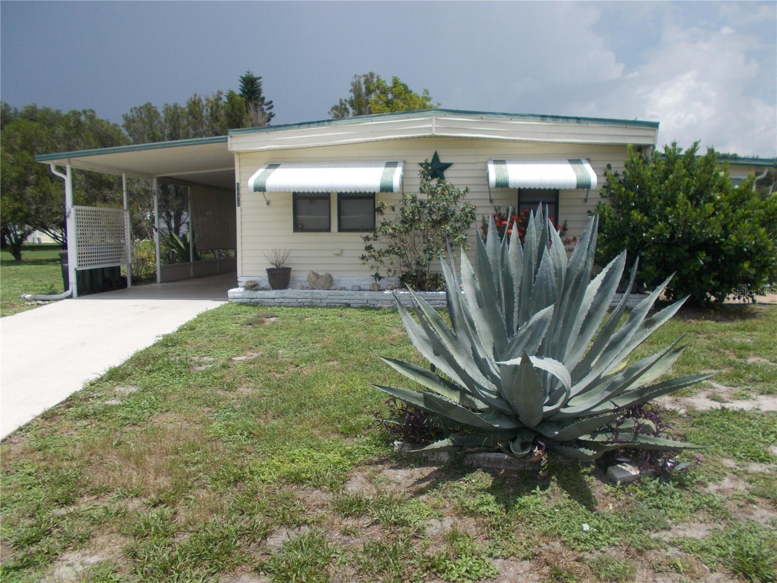 This is a 2-bedroom, 2 bath, unfurnished Doublewide home located in the PET SECTION of the gated Mobile Home Community of Holiday Park. The home is located in a cul-de-sac. This home features a Dining Room, Living Room and a Florida Room. Both bathrooms have showers. The primary bedroom is in the back of the home. As per the property records the roof is a 2015 and the AC is 2017. Your Washer & Dryer are in the Bathroom #2. In Holiday Park you own the land with a deed and your $195.00 monthly maintenance fee ($2340.00 a year) is included in your taxes. The community features 2 clubhouses, 2 swimming pools, a library, a fitness room, tennis courts, pickleball & bocce courts, to name a few. You are close to shopping, dining, entertainment, numerous golf courses, sports facilities, and SW Florida's renowned beaches. Come take a look!