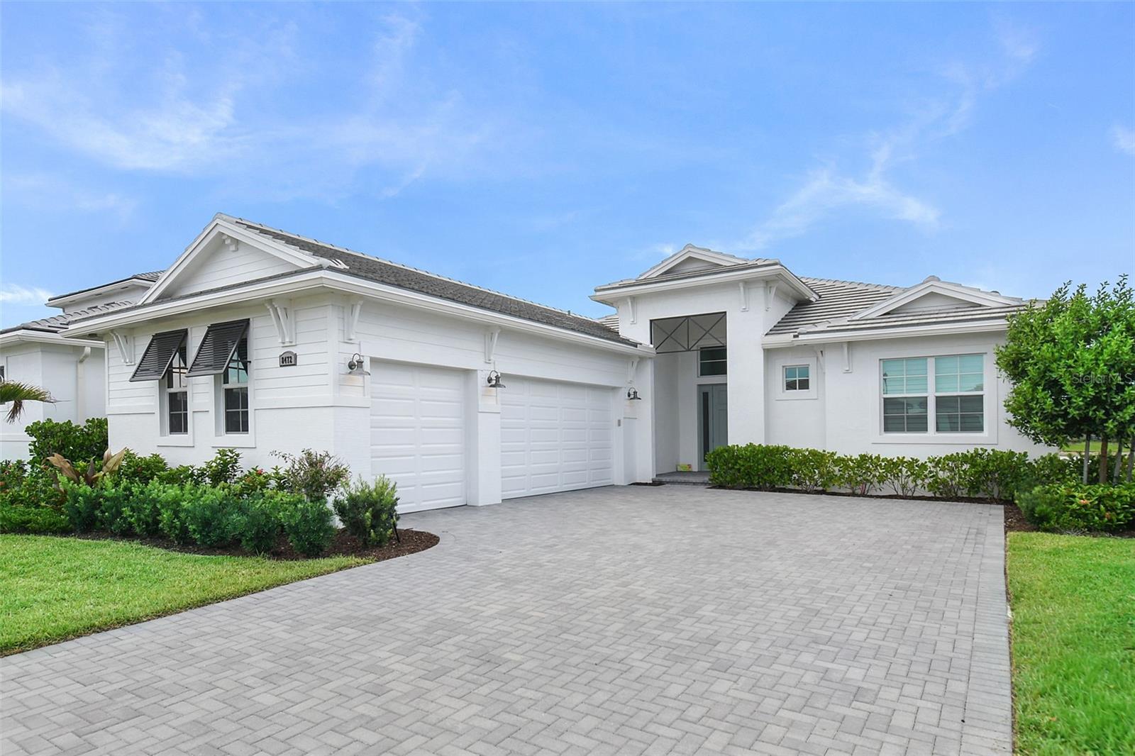 Experience exceptional Florida resort-style living in the gated community of PGA Verano! This nearly new and meticulously maintained Riley model offers three spacious bedrooms, each with its own private en-suite bath. Thoughtfully upgraded throughout, this home features an expanded primary suite with an additional four feet of living space, dramatic L-shaped sliding glass doors that seamlessly open the living and kitchen areas to the covered patio and serene lake views, and a highly desirable third garage bay. The open-concept floor plan includes a generous breakfast bar, walk-in pantry, and versatile office/den, with impact windows, while plantation shutters add timeless elegance throughout. Just two years old and lovingly cared for, this lakefront home is move-in ready. Residents of PGA Verano enjoy access to the spectacular Club Talavera amenities, including indoor and outdoor resort-style pools, a state-of-the-art fitness center, 27 pickleball courts, bocce ball, billiards, basketball, and tennis courts. Golf enthusiasts will appreciate private golf cart access to three championship courses at PGA Golf Club. Enjoy the perfect blend of luxury, comfort, and an unmatched amenity-rich lifestyle in one of the Treasure Coast's premier communities.