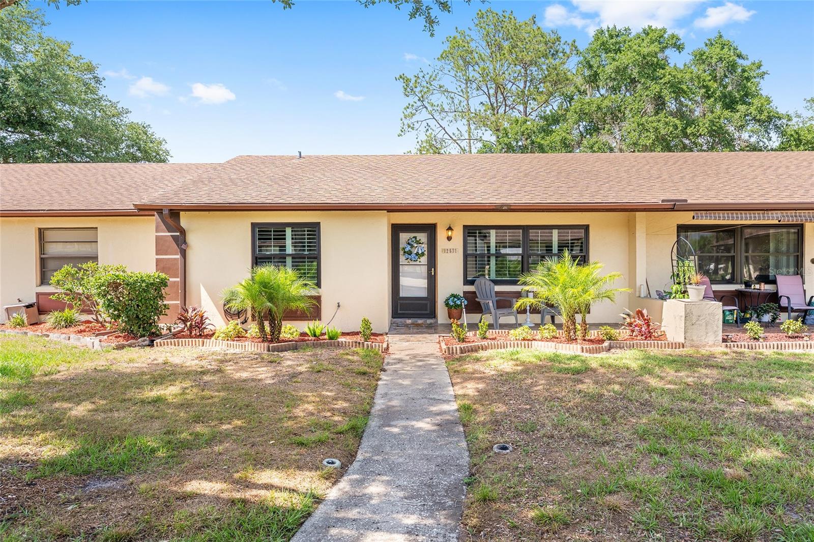 One or more photo(s) has been virtually staged. FRESHLY REMODELED and MOVE IN READY, this updated 2 bed/2 bath villa in the 55+ community of Summit Chase Villas offers a clean, modern and comfortable feel with a long list of NEW UPDATES. This all electric block/stucco home features NEW STAINLESS STEEL APPLIANCES, NEW WASHER & DRYER, NEW FLOORING, FRESH INTERIOR PAINT, Updated PLUMBING & ELECTRICAL, Anderson windows (2022), HVAC (2022), PLANTATION SHUTTERS, and CROWN MOLDING in the main living areas. The kitchen was FULLY REMODELED in 2026 with soft close cabinetry, butcher block counters, custom wood shelving in the Pantry, TILE BACKSPLASH, an oversized STAINLESS STEEL sink, and a pass through opening to the Florida room. The primary suite includes DUAL CUSTOM CLOSETS and an updated en-suite bath with custom wood shelving in the linen closet, while the guest bath offers a SAFE STEP WALK IN JETTED TUB. A tiled Florida room overlooks the backyard and connects to a dedicated laundry/storage room. Exterior highlights include updated landscaping, gutters, and a COVERED PARKING SPACE WITH STORAGE! —The HOA includes ROOF REPLACEMENT, EXTERIOR PAINT, MOWING, COMMUNITY POOL, CLUBHOUSE, and SHUFFLEBOARD. Convenient Tavares location close to Publix (0.7 mi), and easy access to waterfront dining, shopping, medical facilities, downtown Tavares and Mount Dora, and the beautiful Harris Chain of Lakes — all while enjoying the relaxed Florida lifestyle that America’s Seaplane City is known for. Don’t miss this GEM, call to schedule your private showing TODAY!