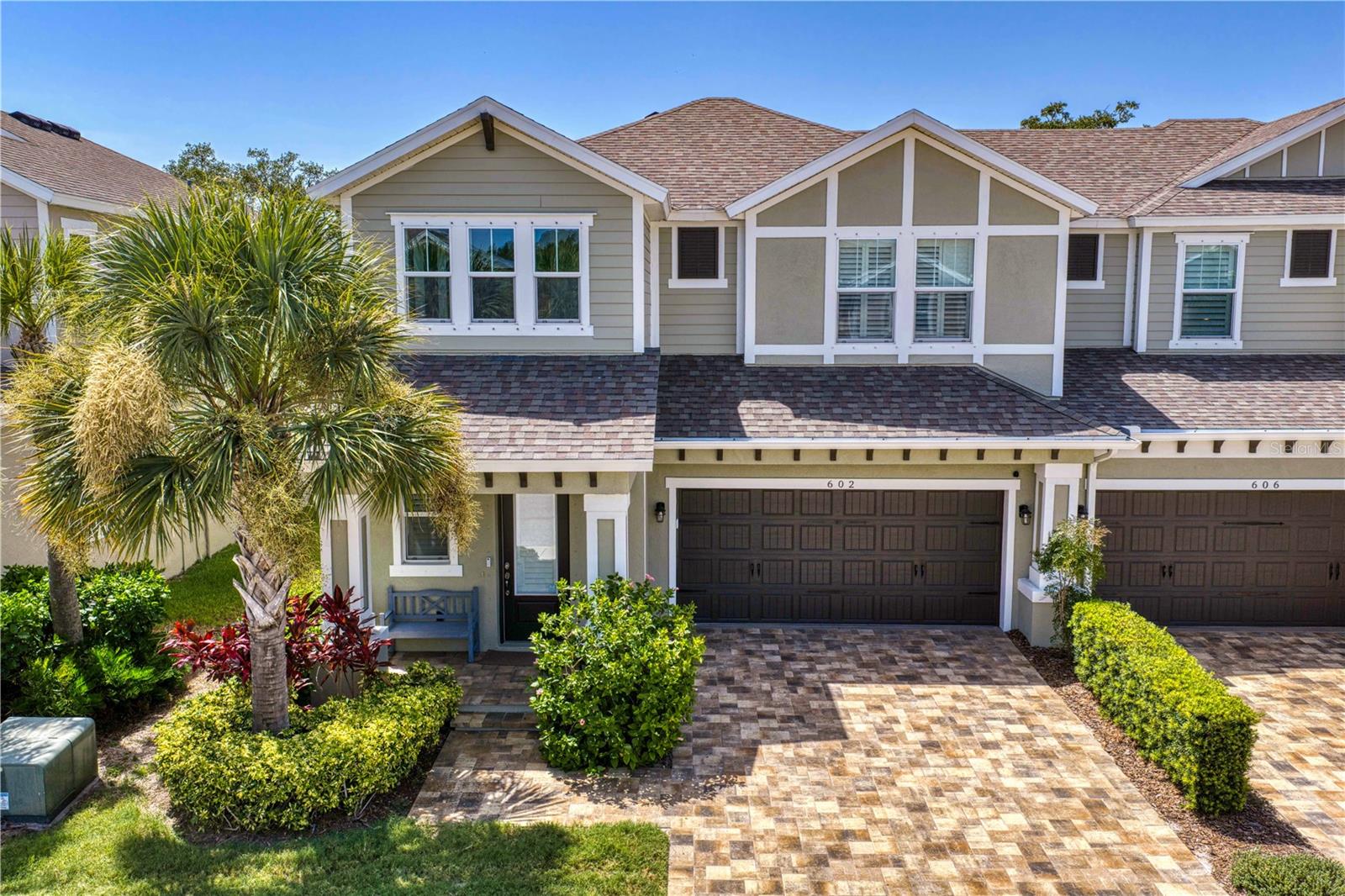 Nestled in the heart of Ozona Village, this beautifully designed townhome offers an effortless blend of refined finishes, low-maintenance living and the relaxed charm of one of Pinellas County's most beloved coastal communities. Built in 2019, this three-bedroom, three-bath residence offers 2,324 square feet of thoughtfully designed living space, where timeless design and quality craftsmanship create a home equally suited for everyday living and effortless entertaining. A welcoming, light-filled interior unfolds with high ceilings, an open-concept floor plan and elegant finishes throughout. At the heart of the home, the beautifully appointed kitchen features quartz countertops, premium cabinetry, stainless steel appliances and an expansive island that seamlessly connects to the living and dining areas, creating an inviting space for gathering with family and friends. One of the home's most distinctive features is its peaceful outdoor setting. The screened lanai overlooks a tranquil pond framed by mature magnolia trees, providing a private backdrop that feels both serene and distinctly Old Florida. Whether enjoying a quiet morning coffee or unwinding at sunset, the setting offers a rare sense of privacy within the community. Designed with both comfort and functionality in mind, the flexible floor plan provides spacious bedroom accommodations, beautifully appointed baths and abundant storage throughout. A whole-home generator adds an additional layer of convenience and peace of mind, allowing you to enjoy the home with confidence year-round. Beyond the residence itself, the lifestyle is what truly sets Ozona Village apart. Residents enjoy the benefits of newer construction while being just moments from local marinas, waterfront dining, neighborhood taverns and the vibrant charm that has made historic Ozona one of Tampa Bay's most treasured communities. The Pinellas Trail is directly adjacent to the neighborhood, while downtown Palm Harbor, Dunedin and Tarpon Springs are all just a short bike ride or golf cart ride away. The community offers maintenance-free living with a resort-style pool and cabana, while the HOA includes exterior maintenance, cable, internet, water, sewer and trash. Sophisticated yet welcoming, 602 Ozona Village Drive offers the perfect balance of modern convenience, timeless design and the unmistakable character of Ozona living. Additional photos to follow shortly.
