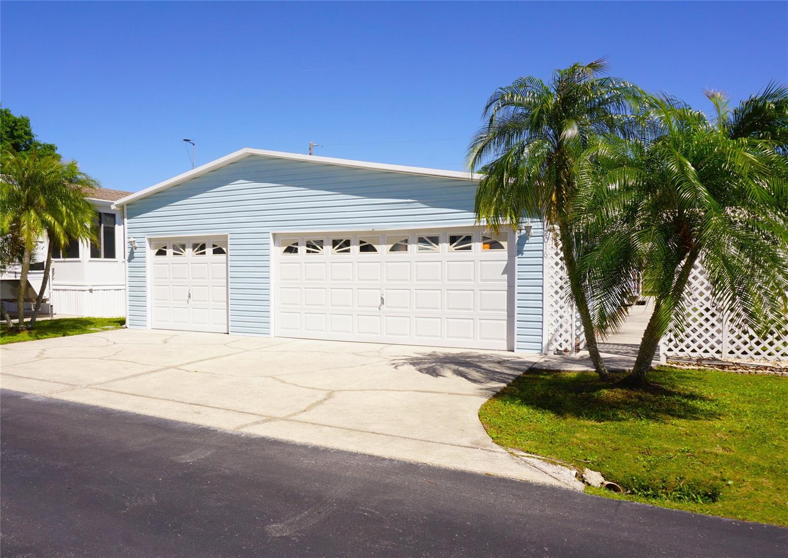 Single level double-wide home located in the gated nudist co-op community of Lake Linda. This light and bright home has 2-Bedrooms/2-Baths, neutral colors/flooring, and an open floorplan. The kitchen features plenty of cabinets, dual sink, range, dishwasher, fridge, closet pantry, and eat-in breakfast nook. Combination living/dining room with vaulted ceiling. Primary bedroom has a wall-to-wall closet and full en-suite bath with a garden tub and door to the main living space for guests. The second bedroom has an ensuite bath with tub/shower combination and wall-to-wall closet. Full size washer and dryer included. Park your vehicles in the attached 3-car garage with dual doors, dual electric openers, and separation wall door between the 2-car and 1-car side. Sliding doors from the living/dining space lead to a screened covered patio/lanai with a door to the rear yard. Existing furnishings, appliances, and decor included and convey as is. Buyer is responsible for verifying all information, details and dimensions. This lovely home is located in a co-operative community. New members receive a proprietary 99-year land lease. Co-op/association approval of Buyer is required including application, fee, background check, orientation, and membership in a recognized nudist organization. Lake Linda features a community pool, clubhouse, BBQ area, and tennis courts.