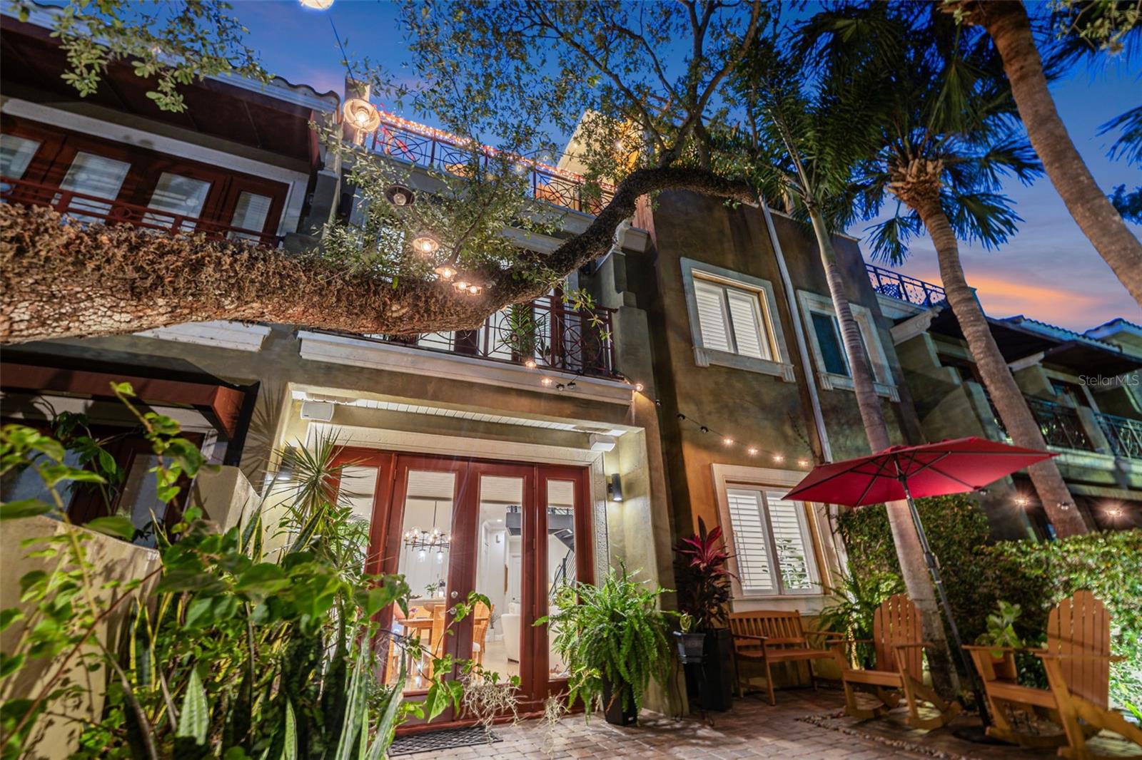 Experience a rare blend of timeless sophistication and urban luxury in this extraordinary SOUTH TAMPA Townhome positioned along iconic BAYSHORE Boulevard. Evoking the elegance of a residence tucked beside Central Park or along Manhattan’s Upper East Side, this one-of-a-kind home offers an elevated lifestyle surrounded by the beauty of Tampa Bay and the charm of Bayshore’s tree-lined waterfront promenade. Beyond the private gated garden terrace wrapped in lush ivy-covered walls, step directly onto Bayshore Boulevard’s world-famous continuous sidewalk where miles of scenic waterfront walking, running, and biking await right outside your door. Inside, the residence unfolds across three thoughtfully designed levels connected by a striking custom metal staircase that serves as a true architectural centerpiece rarely found in townhome living. Refined interiors, sophisticated finishes, and effortless indoor-outdoor flow create an atmosphere that is both luxurious and inviting. The chef’s kitchen is equipped with NATURAL GAS and a gorgeous WOLF RANGE, perfectly suited for both everyday living and elevated entertaining. The second level features three spacious bedrooms including a stunning primary suite complete with French doors opening to a Juliet balcony overlooking Bayshore Boulevard, framed by the canopy of majestic grandfather oak trees. The serene setting feels both intimate and cosmopolitan. Designed with entertaining in mind, the third level is an experience unto itself. This private retreat opens to an incredible rooftop terrace featuring covered lounge space for evenings under the stars, outdoor television viewing, a pizza oven, and a brand-new high-end grill creating the ultimate al fresco entertaining environment. For the wine enthusiast, a spectacular climate-controlled GLASS ENCLOSED WINE CELLAR that holds 800-1000 bottles becomes a true showpiece, complemented by a prep kitchen ideal for hosting wine tastings, intimate gatherings, or elevated dinner parties. A full bath on the third floor adds flexibility and convenience for guests and entertaining. With 3 bedrooms, 3 full baths, and 1 half bath, this exceptional residence offers the perfect balance of luxury, functionality, and lifestyle in one of Tampa’s most coveted waterfront locations. This is more than a home — it is a statement in sophisticated Bayshore living....only minutes to Hyde Park Village, Ballast Point Park, Downtown, Water Street, museums, dining, and Tampa General. Quick access to MacDill AFB and Tampa International Airport makes this the perfect home for both work and play. LOW HOA ONLY $310 PER MONTH.