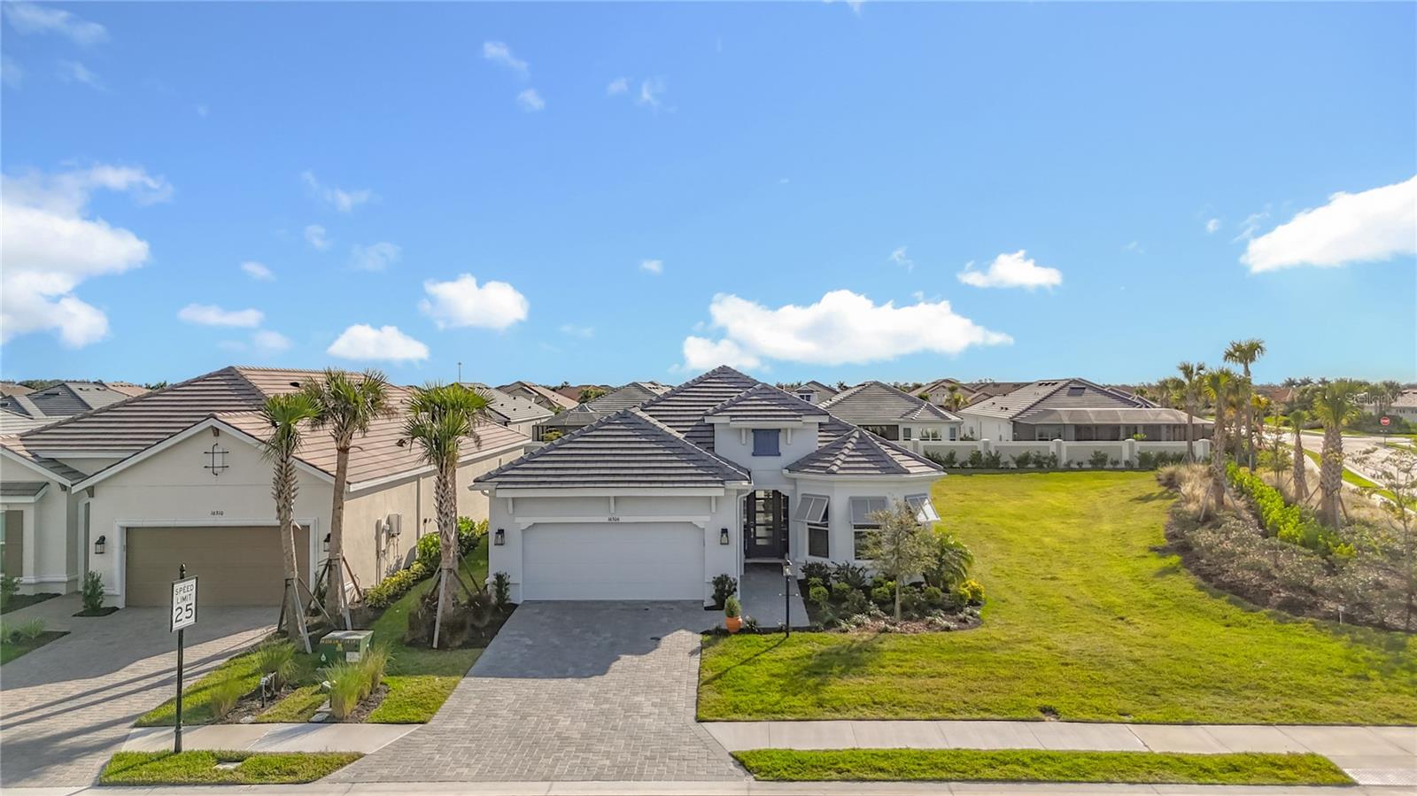 Located in the sought-after community of Azario in Lakewood Ranch, this professionally decorated single-family home on a corner lot, offers luxury living with an open, entertainer-friendly design. The home features three bedrooms, three full bathrooms,  an over sized garage, and a versatile flex room/office that  easily serve as a fourth bedroom. The gourmet kitchen showcases quartz countertops, upgraded cabinetry, stainless steel appliances, tile backsplash, and an oversized island with prep sink and built-in bar refrigerator.  The open floor plan flows into the eat-in dining area and spacious family room with tray ceilings and large sliders that flood the home with natural light. Enjoy seamless indoor-outdoor living on the private lanai featuring a built-in outdoor kitchen, fireplace, and a heated pool and spa with sun shelf and waterfall features.  The home offers two primary suites with walk-in closets  and spa inspired baths with double quartz vanities and porcelain tile.  Additional highlights include upgraded hardwood floors, hurricane impact windows and doors, custom window treatments,2+ car garage and decorative wallpaper.  Residents enjoy resort-style amenities including a golf course, spa, fitness center, tennis and pickleball courts, community pools, culinary center with formal and casual dining, social clubs, coffee shop, and dog parks. New this year all residents can get a golf membership for  $8,000.00 for a single and $11,000.00 for and family , time to play.