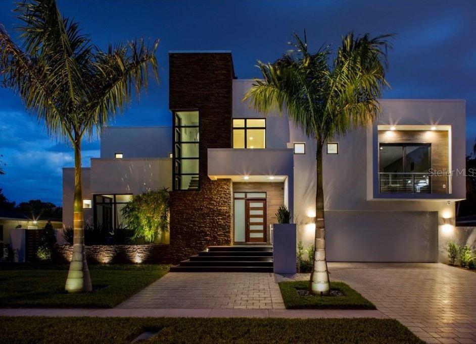 Thoughtfully designed and impeccably built, this exceptional Snell Isle residence reflects the vision of a local custom home builder who crafted the home for personal living, with no detail overlooked. Spanning 3,784 square feet, the home blends refined architecture with natural stone accents and an effortless connection between indoor and outdoor spaces, all enhanced by abundant natural light.

Designed for both everyday living and entertaining, the open interior features 10’ ceilings and a gourmet kitchen equipped with Sub-Zero, Wolf, and Miele appliances, opening to the Great Room and expansive outdoor living areas. The oversized lanai includes a fully equipped outdoor kitchen, interior and exterior fireplaces, and overlooks a resort-style pool and heated spa for year-round enjoyment.

The primary suite occupies its own private level, offering front and rear balconies for peaceful retreats. Upstairs also includes a game room loft, a private study, and two en-suite bedrooms, while a downstairs guest suite provides ideal privacy or flexible office space.

Additional highlights include an oversized two-car garage, whole-home surround sound, smart-home features, whole-house generator, on-demand gas water heaters, extended HVAC warranties, and construction built one foot above FEMA requirements—all set within one of St. Petersburg’s most desirable neighborhoods.