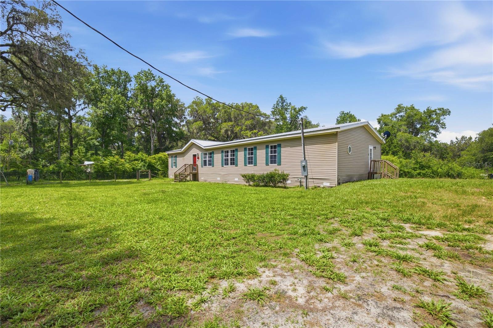 NO HOA! Metal Roof (2021) & Brand-New AC! Welcome to peaceful country living in Citra! This spacious 4-bedroom, 2-bath home offers approximately 2,280 square feet of comfortable living space and sits on a private, fully fenced lot of nearly an acre. The thoughtfully designed split-bedroom floor plan features formal living and dining areas, plus a large great room highlighted by a beautiful wood-burning fireplace. The oversized eat-in kitchen is perfect for gathering and entertaining, offering abundant cabinet space, a center island, pantry, and convenient bar area. The primary suite provides a relaxing retreat with a garden tub, separate shower, walk-in closet, and an additional flex space ideal for a home office, nursery, or sitting area. Recent improvements include a metal roof installed in 2021, brand-new AC system, updated HVAC ductwork, fresh interior paint, updated light fixtures, and newer flooring. Additional features include inside laundry, well and septic, water softener, and no HOA restrictions. Enjoy the privacy and tranquility of rural Marion County while still being conveniently located near Ocala, Gainesville, and major highways. Outdoor enthusiasts will appreciate the property's proximity to numerous lakes and recreational waterways, including Orange Lake, Lake Kerr, Little Orange Lake, Newnans Lake, and the Ocklawaha River, offering opportunities for boating, fishing, kayaking, and nature exploration. Whether you're looking for room to grow, space for hobbies, or simply a quiet place to call home, this property offers the perfect blend of comfort, convenience, and country charm!