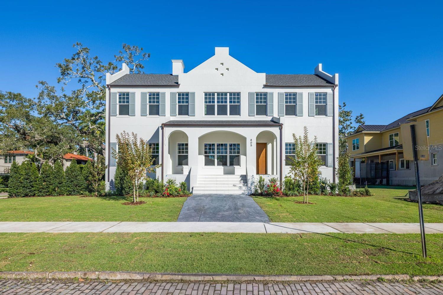Under Construction. Est. Completion: February 2026 | This is a CANOPY SIGNATURE HOME in collaboration with LAUREN LEITNER DESIGN Would you like to live steps from BEACH DRIVE in St. Petersburg's most sought-after neighborhood of Historic Old Northeast? Don’t miss the chance to make this your dream home with Canopy Builders—St. Pete’s most trusted name in luxury home construction. This ALL BLOCK new build on a CORNER lot (80 x 110) features 4 Bedrooms + Loft, 4 Baths, an oversized 2-car garage, a raised POOL & SPA, plus an Accessory Dwelling Unit (ADU) with an additional 1 bedroom and 1 bath. The main home offers 3,633 sqft of living space and 571 sqft in the ADU (total: 4,204 sqft). The ADU also includes a full kitchen, laundry area, and generous walk-in closet. Set among picturesque brick streets and mature oaks, this stunning home is surrounded by charm and architectural beauty. You're just a 10-minute WALK to downtown St. Pete and a short stroll to scenic waterfront parks. A welcoming front porch invites you to relax and enjoy the neighborhood’s vibe. Step through the front door with into an exquisite open-concept great room and dining area, where sophistication meets comfort. To the left, a beautifully appointed guest suite/office features a spacious walk-in closet and a bathroom just outside the room. Flowing seamlessly from the great room with stained white oak beams and tongue and groove ceiling, the chef’s kitchen—with Calcutta marble counters, a La Cornue range, and custom cabinetry—is equipped with a walk-in pantry and designed for both style and functionality. Just off the kitchen, a mudroom offers access to the garage and the perfect space to keep daily essentials organized. Upstairs, you'll find two guest bedrooms and a laundry room with sage colored cabinetry and a built-in sink for added convenience. Down the hall, a loft offers endless potential for entertainment or relaxation. The luxurious primary suite is a true sanctuary, boasting dual walk-in closets and a spa-inspired ensuite featuring a fluted white oak vanity, gold hardware, and unique tile, with dual vanities and a private water closet. Step onto the expansive balcony and take in the view of your resort-style backyard. A winding spiral staircase leads down to your private outdoor oasis—complete with a shimmering pool, spa, and fully equipped outdoor kitchen. Above the garage, the spacious 1 bedroom, 1 bathroom ADU that provides the perfect retreat for guests or additional living space. Several key features have already been planned, a tankless gas water heater, impact-resistant windows, and engineered hardwood flooring throughout. Dual digital thermostats allow independent climate control on both levels. Additional luxury elements include 10’ ceilings on both floors, vaulted ceilings in the loft, primary suite, and bedroom 3, as well as 8’ interior doors. Canopy’s signature gas sconce adds an elegant touch to the front porch. The expansive backyard, featuring a fully designed pool & spa and outdoor kitchen, offers ample space for lounging and entertaining. Enjoy a 20-minute drive to St. Pete Beach and only 20 minutes to Tampa. Don’t miss the opportunity to make this breathtaking home yours today!