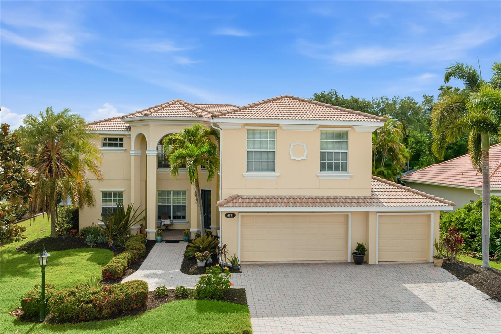 Elegant estate-style lakefront residence with breathtaking sunset and preserve views, offering exceptional indoor and outdoor living in the sought-after gated community of Red Hawk Reserve. Perfectly positioned on a premier lakefront homesite, this impressive two-story home features 5 bedrooms, 3 bathrooms, a bonus/game room, and over 3,800 square feet of living space, showcasing the highly desirable Grand Bristol LS V floor plan with timeless Mediterranean-inspired architecture, lush tropical landscaping, and a dramatic covered entry.

The outdoor living experience is truly one of this home’s standout features, thoughtfully designed for both luxurious entertaining and everyday relaxation. Enjoy an outdoor kitchen and bar, expansive covered living areas, a retractable awning with lighting, and breathtaking lakefront sunset views that create the ultimate Florida lifestyle setting. For peace of mind, the home features hurricane-resistant windows and doors on the front and complete hurricane panels for the rear.

Inside, soaring ceilings, crown moldings, and expansive living spaces are filled with natural light, creating a warm yet sophisticated atmosphere throughout. The open-concept kitchen is designed for both entertaining and everyday living, featuring granite countertops, rich wood cabinetry, built-in appliances, a large center island, breakfast bar, and a breakfast nook overlooking the main living areas.

The flexible floor plan includes a full downstairs bedroom suite or office, while upstairs offers spacious guest bedrooms, a large bonus/game room, and a private sitting area adjoining the luxurious primary suite. The primary retreat also features access to a private second-story screened balcony overlooking the pool, lake, and preserve—the perfect place to unwind and enjoy peaceful sunset views.

The versatile loft area provides the ideal space for a media lounge, secondary living area, or game room, while additional bedrooms offer exceptional comfort and privacy for family and guests. As evening approaches, retreat to your private outdoor oasis and unwind in the jacuzzi while taking in breathtaking sunset views over the water. Whether entertaining family and friends or enjoying a peaceful evening at home, this is Florida living at its finest.

Designed to embrace Florida’s signature indoor-outdoor lifestyle, the expansive screened lanai features a resort-style heated pool and spa, covered outdoor living spaces, and tranquil water views framed by mature oak trees and tropical landscaping. The lush grounds are maintained by a four-zone irrigation system utilizing reclaimed water.

Perfectly positioned across from the 123-acre Twin Lakes Park, this exceptional residence offers an unparalleled lifestyle surrounded by recreation, nature, and convenience. Just a 5-minute walk from your front door, enjoy miles of walking trails, newly appointed pickleball and tennis courts, and one of the area’s most robust sports and recreational complexes. The park is home to football and cheer programs, as well as soccer, baseball, and basketball, bringing activity to the neighborhood year-round.

Be sure to experience the immersive 3D Matterport virtual walkthrough. Schedule your private showing today and discover everything this remarkable lakefront estate has to offer.