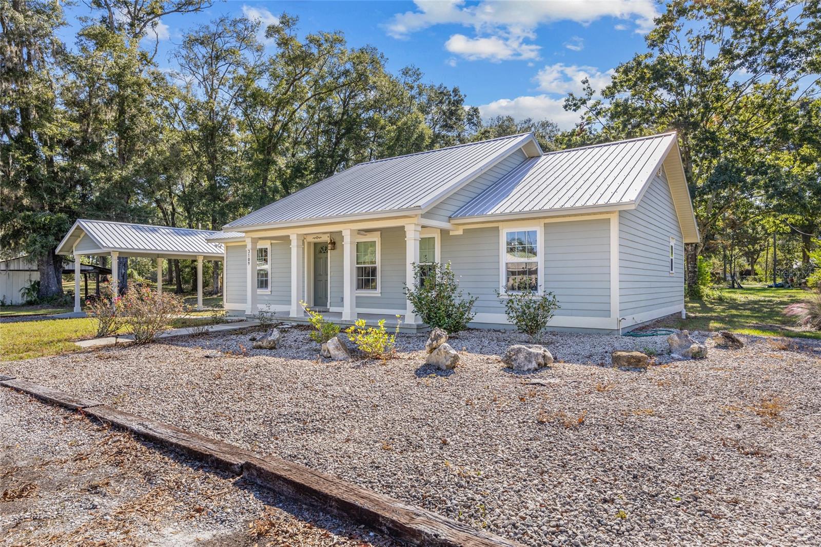 Welcome to this lovely 2-bedroom, 2-bathroom home nestled in the peaceful town of Bell, FL! Built with durability in mind, this home is hurricane-resistant, featuring a secondary roof and soundboard walls in the living room for added safety and tranquility during stormy weather. Designed with accessibility in mind, the home is fully equipped for handicap use, ensuring comfort and convenience for all. Inside, you'll find an open and inviting layout, with a spacious living room filled with natural light. The well-appointed kitchen offers ample cabinet space for storage, while the two comfortable bedrooms provide privacy and relaxation. The bathrooms are thoughtfully designed, with one featuring an ensuite for added convenience. The exterior of the home includes a covered carport, perfect for protecting your vehicle from the elements, along with a pump house that provides extra storage space. Set on a peaceful lot, this home offers the ideal spot for gardening, relaxing, or enjoying the quiet charm of small-town living. Conveniently located just minutes from local schools, shops, and parks, this home combines modern safety features with easy access to everything you need. Don't miss the opportunity to make this one-of-a-kind home yours!