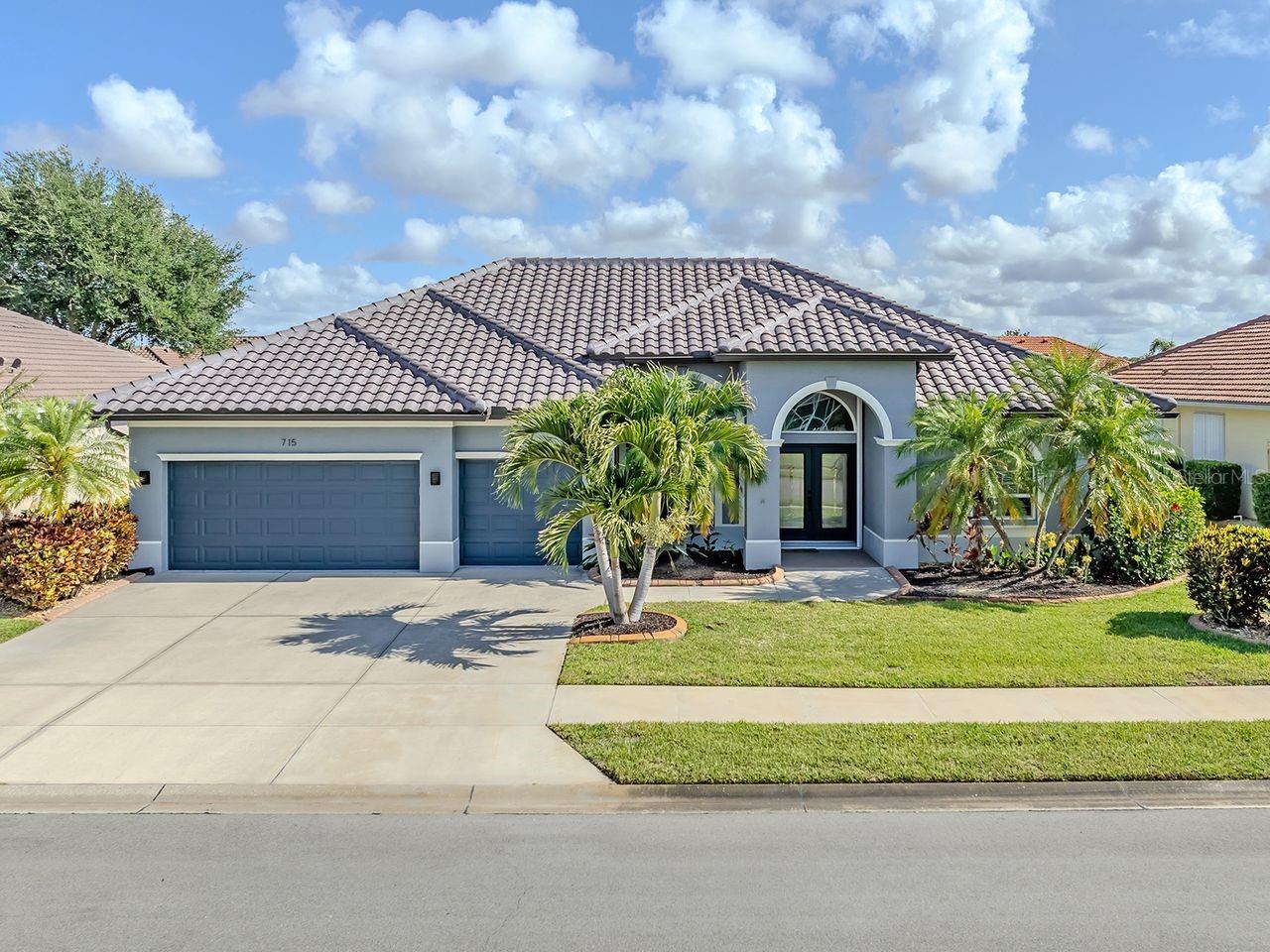 PRICE IMPROVEMENT! MOVE-IN READY! This stunning custom quality-built J&J Aruba model 3 home that offers over 2.300 square feet of spacious living with 3 bedrooms, 2 baths and an oversized 3-car garage. Beautifully updated and well maintained, this home features a newer BARREL TILE ROOF (2025), new elegant granite countertops with granite backsplash, newer kitchen sink, faucet & garbage disposal, recirculating Hot Water Pump & more for added convenience. Designed for both entertaining and everyday comfort, Spilt bedroom plan for privacy, family & guests. Open floor plan with 12-foot ceilings, crown molding, transom windows, and walls of sliding glass doors that fill the home with an abundance of natural light. Diagonal tile flooring flows throughout the main living areas, while luxury vinyl flooring in the bedrooms provide both style & easy care. The cook's kitchen is a dream with center island, gorgeous stone surfaces, granite backsplash & an abundance of cabinets. Sparkling heated resort style pool & lush landscaping provide a tranquil oasis. The spacious primary suite brings a relaxing retreat with dual sinks, garden tub, roman shower, and generous space to unwind. Hurricane shutters provide safety and protection for the entire home. Seller providing one year home warranty for Buyer for peace of mind.
Enjoy the Florida lifestyle in the highly sought after Lakes of Jacaranda, featuring a clubhouse with year-round social activities, junior Olympic pool, tennis & pickleball courts & scenic trails. Centrally located near historic downtown Venice, Gulf beaches, sunsets, fishing, golf courses, & the Atlantic Braves spring training stadium, this truly offers the best of Southwest Florida living. Low HOA fees, no CDD fees, & no required flood insurance make this exceptional property even more attractive. Some photos have been virtually staged.