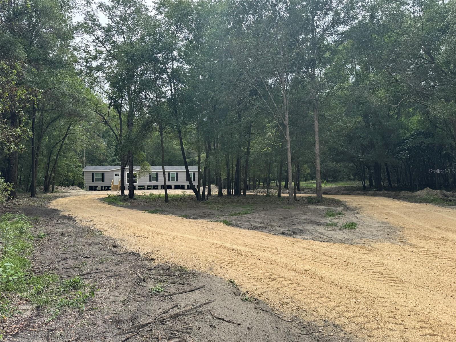 Brand-New 4BR/2BA Mobile Home on 5 Private Acres in High Springs

Be the first to live in this beautiful brand-new 4-bedroom, 2-bathroom manufactured home offering approximately 1,700 square feet of thoughtfully designed living space on 5 private acres in scenic High Springs, Florida. This spacious home also features a dedicated study/home office, making it ideal for remote work, hobbies, or additional living space.

Inside, you’ll find an open-concept floor plan with a bright living area, modern kitchen with abundant cabinetry and counter space, spacious bedrooms, and a private primary suite featuring an ensuite bath and generous closet space. Enjoy the peace and privacy of country living while still being within easy reach of nearby conveniences.

Nestled in the charming community of High Springs, this property is just minutes from some of North Florida’s most popular natural attractions, including Ginnie Springs, Poe Springs, Blue Springs, and the Santa Fe River, offering endless opportunities for swimming, kayaking, tubing, snorkeling, and outdoor recreation. Conveniently located approximately 30 minutes to Gainesville, 33 minutes to Lake City, and with easy access to Alachua and surrounding communities.

Important Photo Disclaimer: Interior photos shown are of the builder’s model home and are provided to represent the floor plan and finishes. The exterior photos depict the actual home and property. The home is currently being completed, and skirting will be installed prior to occupancy.

Experience the perfect combination of modern living, privacy, and natural beauty—schedule your showing today!
