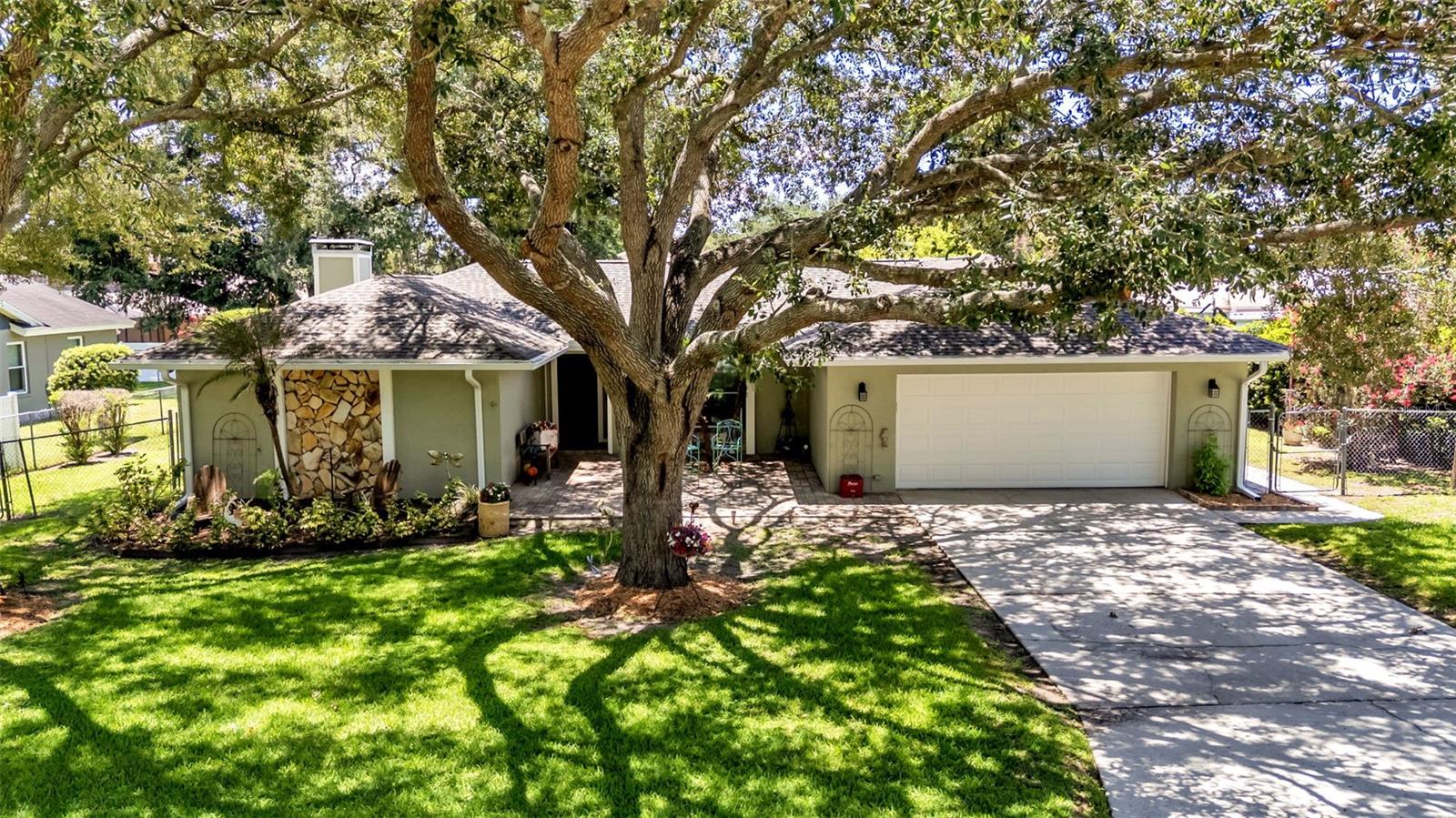 Welcome to this beautifully maintained 4-bedroom, 2-bath pool home in one of South Lakeland's most established and desirable neighborhoods. From the moment you arrive, you'll appreciate the attractive curb appeal, highlighted by lush landscaping, meticulous maintenance, and an impressive 19' x 23' pavered entry that creates a warm and welcoming first impression. Inside, the open floor plan offers comfortable everyday living and effortless entertaining. The updated kitchen features freshly painted cabinetry, granite countertops, newer appliances, a decorative tile backsplash, and a double oven with convection and air fryer capabilities. Two kitchen skylights fill the space with natural light and feature integrated night-light functionality, providing a soft glow in the evenings. Entertaining is made even easier with the convenient pass-through window to the Florida room from the kitchen. The spacious living room offers durable vinyl flooring and a cozy wood-burning fireplace, creating the perfect gathering space. The primary suite features private patio access through sliding glass doors, a large walk-in closet, and a beautifully remodeled en-suite bathroom with updated cabinetry and attractive tile finishes. The Florida room provides additional year-round living space with its own mini-split system,  and abundant windows overlooking the backyard and pool area. The fourth bedroom includes a closet and offers flexibility as a home office, guest room, or hobby space. Step outside to enjoy the screened, resurfaced deck and gunite pool, complete with an automatic cleaner. The fully fenced backyard provides plenty of room for pets and outdoor activities, while the storage shed with electricity offers excellent space for projects, hobbies, or additional storage. Additional highlights include a true two-car garage with extensive cabinetry, abundant storage space, and washer and dryer hookups. Recent updates provide exceptional value and peace of mind, including a 2019 water heater, 2021 double-pane windows and sliding glass doors, and a beautifully updated primary bathroom (2024). Additional improvements include a new drain field, new gutters, fresh exterior paint, and added blown in  attic insulation (2025). In May 2026, a new roof was installed and includes a 10-year transferable warranty. The HVAC system has been recently serviced and is equipped with a Clean Comfort UV Kit, REME HALO air purification system, and an electrostatic filter for enhanced indoor air quality. The pool pump received a new motor and electrical components in 2026. To top it all off, the home includes a transferable Choice Home Warranty, valid through January 24, 2027.Conveniently located near the Polk Parkway and I-4, this home offers quick access to shopping, dining, hospitals, medical facilities, and emergency services while maintaining the peaceful atmosphere of a well-established South Lakeland community. Combining thoughtful updates, inviting living spaces, and exceptional outdoor amenities, this home is ready for its next owner to enjoy.