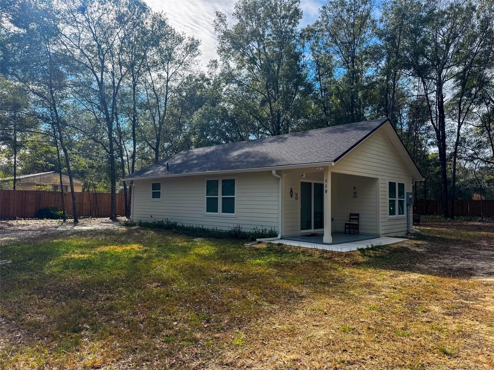 Welcome to this beautifully built 2024 home located on a quiet, wooded lot in Melrose. This 898 sq ft, 1-bedroom, 1-bath home with a bonus room offers modern, low-maintenance living in turn-key, like-new condition. The open-concept layout features luxury vinyl plank flooring, neutral finishes, and abundant natural light. The kitchen includes granite countertops, stainless steel appliances, white cabinetry, and a functional island, opening seamlessly to the living area. The primary bedroom is well-sized with ample closet space, while the bonus room provides flexibility for a home office, guest room, or nursery. The bathroom is finished with modern fixtures and a tiled tub/shower combo. Sliding glass doors lead to a peaceful backyard surrounded by mature trees. With new construction quality and no updates needed, this home is ideal for a first-time buyer, downsizer, or anyone seeking a move-in-ready property in a quiet North Florida setting.