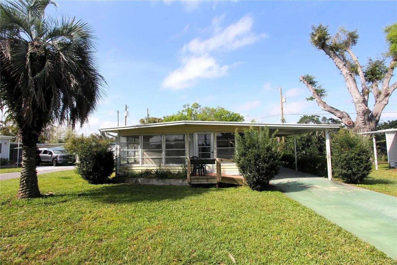 This charming double-wide home in the highly sought-after 55+ Green Hills Estates sits on a desirable corner lot, and offers the perfect blend of comfort, space, & opportunity. While it needs a little TLC, the seller has already made key updates, including new flooring in the living room, plush carpet in the bedroom, and a stylish vanity in the bathroom, leaving room for you to add your personal touch. Step inside to find a bright, open layout with plenty of natural light and a flexible floor plan you can customize to fit your needs. One of the standout features is the beautiful Florida room, perfect for enjoying your morning coffee, hosting friends, or simply relaxing in the peaceful surroundings. Located in a quiet, friendly community with low HOA fees and a welcoming clubhouse,  this home provides affordable Florida living just minutes from shopping, dining, and all that Zephyrhills has to offer. With endless potential, a little TLC, and a motivated seller ready to make a deal, now is the perfect time to bring your offer today.