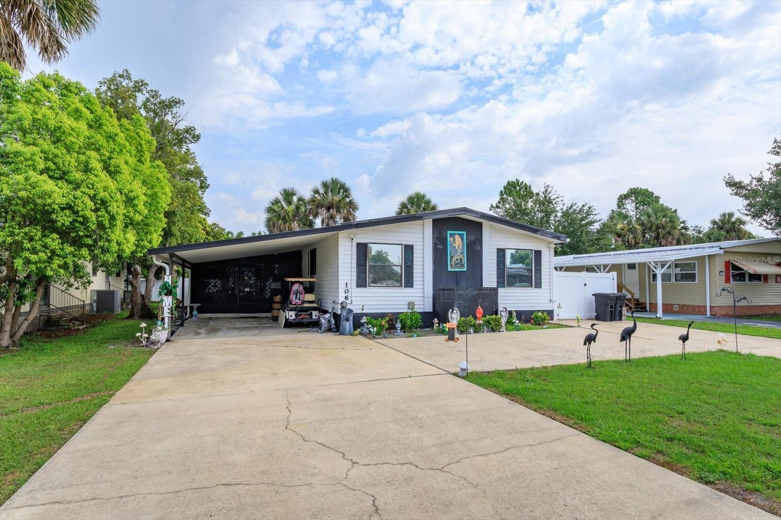CHECK THIS ONE OUT!!  4TH OF JULY SPECIAL!!  A HUGE 3-BEDROOM MANUFACTURED HOME WITH AN ENORMOUS OVERSIZED LOT AND AN EXTRA LARGE 28 x 15 SCREENED PORCH WITH BOAT ACCESS TO THE ST JOHNS RIVER!!!!  PLENTY OF PARKING WITH TWO DRIVEWAYS AND U-SHAPED FOR EASY IN & OUT ACCESS.  Come & see this 1404 sq ft home located in the beautiful community of Meadowlea on the River.  Spacious three bedrooms and two bathrooms with a super nice floor plan and vinyl upgraded faux wood flooring throughout the home. A very COLORFUL home with a tropical and mermaid style. Magnificent, screened porch that serves as an entertainment center with large screen TV and living room setup. Relaxing combo dining room/living room with fireplace.  Cute & cozy kitchen with upgraded Samsung appliances and island table for casual dining and two skylights to let in more natural light. Double front doors that open up into the home for easy entry and furniture delivery.  Very large primary bedroom with very nice bathroom with big garden tub and separate shower and two huge walk-in closets for plenty of storage for your clothes and personal items.  The interior laundry room has two storage closets, separate utility sink and washer & dryer that convey with the sale.  Vinyl lifetime fence with two gates which enclose the large back yard and two large storage sheds for all your lawn care equipment and tools.  Home is equipped with hardwired Ring security system.  The seller has TOTAL pride of ownership for her home and it shows!! This is a golf cart community where you can enjoy neighborhood rides or walks in the great outdoors with community activities such as bingo, potluck dinners, holiday parties and private events. Meadowlea on the River is a quiet & pristine neighborhood that has great sunrises & sunsets!! Here is your chance to live in a gated community with HOA amenities including clubhouse, pool, playground, pavilion, and RV/Boat parking and storage. Own your own lot with NO LOT RENTAL FEES. Only $63 HOA monthly fee.  Conveniently located with shopping, restaurants & medical facilities close by with easy access to I-4, 417 & Sun Rail Train station. Definitely a must see to appreciate this GEM of the community which won't last long!!!