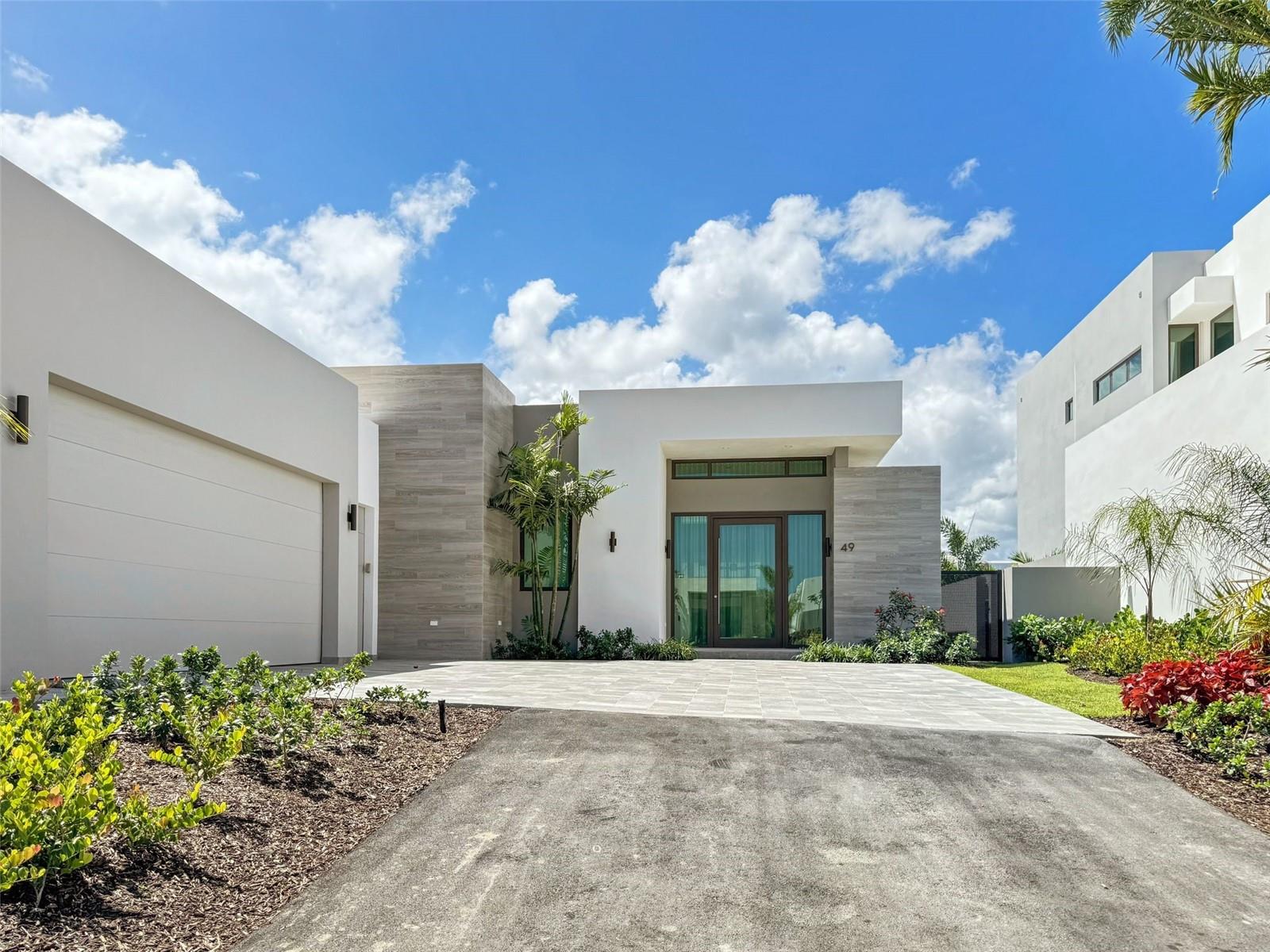 Welcome to your dream home in the exclusive Isles community! This stunning property offers luxury living with modern design and timeless elegance. Fully furnished with 4 bedrooms, 4 bathrooms, and 2 half bathrooms, spanning approximately 3,857 square feet, it's designed for comfort and style. The interiors boast sleek lines, high-end materials, and state-of-the-art fixtures, creating an atmosphere of sophistication and comfort. Enjoy the pool and jacuzzi with a heater and salt system, along with a half bathroom, and a kitchen equipped for gas if desired. Plus, practical amenities include a maid room, covered parking, BBQ area, electric retractable curtains, ceiling fans, a 450-gallon cistern, water softener, and upgraded gardens. Embellished with over $400k in high-end décor and furnishings included with the sale, this home exceeds expectations for refined living. The HOA fee, encompassing front lawn maintenance and garbage collection, amounts to $1,250. Additionally, the property includes a fully-equipped power generator capable of supplying electricity to the entire home.