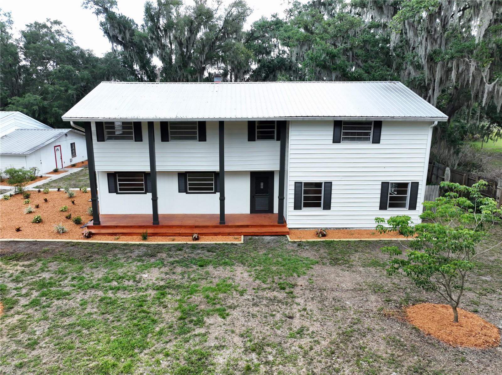 Nestled on over 2 private acres, this beautifully updated property offers the perfect blend of space, functionality, and versatility. At the heart of the property sits a fully remodeled two-story home featuring over 2,600 square feet of living space, 3 bedrooms, and 3 full bathrooms, the property is also set up with a fully equipped 1 bedroom, 1 bathroom ADU and incredible workshop/garage space. Massive 6-car garage/workshop offers endless versatility — ideal for car enthusiasts, storage, hobbies, a home business, gym, studio, or multi-purpose workspace. Surrounded by mature landscaping and multiple styles of fencing including chain link, wood, and wire, the property provides both privacy and flexibility for a variety of lifestyles. Lot split application has been submitted to divide the property in half. Upon approval, pricing for the home will be adjusted accordingly, and the front portion of the property will be offered separately.

The main home and ADU have been thoughtfully refreshed with freshly remodeled kitchens and bathrooms, updated paint, and new flooring throughout including tile, carpet, luxury vinyl plank, and laminate. Elegant crown molding adds character and warmth, while the spacious layouts create a comfortable and inviting feel throughout the home.

The property features a total of 5 bedrooms and 4 bathrooms, including the separate ADU complete with its own kitchen, living space, and central A/C—ideal for guests, multigenerational living, rental income, or a private office setup. Both kitchens are equipped with matching stainless steel appliance packages including refrigerators, microwaves, dishwashers, and ranges for a cohesive modern look.

Outdoor living shines with a sparkling in-ground pool, pavilion area perfect for entertaining, a brand-new front porch, updated exterior lighting, gutters, and fresh exterior paint. Car enthusiasts, business owners, or hobbyists will appreciate the massive 6-car garage/workshop setup complete with an air-conditioned office space and additional covered exterior storage.

The main home features durable vinyl siding with a metal roof, while the ADU is solid block construction and the shop/garage is frame-built with metal siding. Comfort is covered with central A/C upstairs, central A/C in the ADU, and mini-split systems servicing the lower level of the main home.

With extensive updates, flexible living arrangements, and exceptional privacy, this is a rare opportunity to own a truly multifunctional property with room to live, work, entertain, and grow.