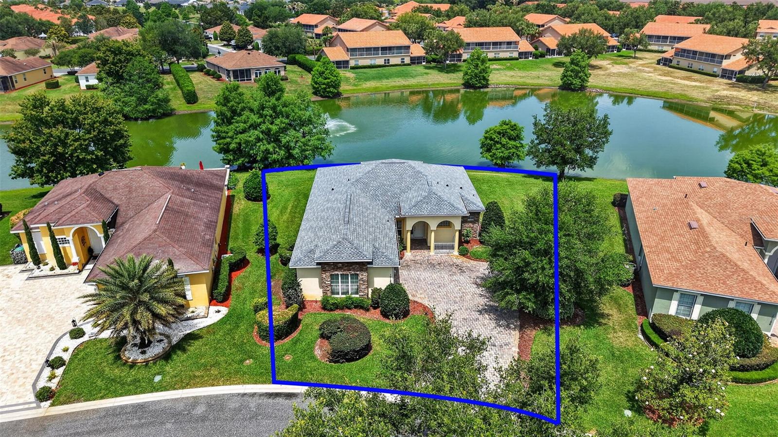 OVERLOOK MAGNIFICENT WATERFRONT VIEWS in this 3/2 BLOCK and STUCCO home nestled on a LARGE, PRIVATE, CUL-DE-SAC LOT in the highly sought-after GATED community of Lakeside Landings - amenities include a lagoon-style pool, hot tub, state-of-the-art clubhouse, and fitness center! Enjoy MAINTENANCE FREE LIVING with HOA-COVERED lawn care, irrigation, trash, and pest control! JUST MINUTES from The Villages retirement community, The Villages Charter Schools, and CR466 offering easy access to a plethora of shopping, dining, banking, medical and more! The STRIKING exterior screams curb appeal with STONE accents, STATELY columns, MATURE landscaping, PAVER driveway, quaint FRONT PORCH, and ARCHED side-lit entry with RETRACTABLE screen that welcome you in to the generous foyer. Soaring 10’ HIGH ceilings and DIAGONAL TILE flooring grace the VOLUMINOUS living, dining, and kitchen areas. The OPEN-CONCEPT offers a SPACIOUS layout that connects these rooms for effortless entertaining and everyday living! From the living room, FOUR-PANEL sliding glass doors invite you in to the EXPANSIVE lanai boasting SPECTACULAR WATERFRONT VIEWS including an ILLUMINATED fountain! This SERENE SETTING is perfect for everything - Whether hosting friends and family or simply savoring a quiet morning coffee - It’s truly an entertainer’s dream and a PRIVATE sanctuary all in one! Back inside, the STUNNING GOURMET kitchen showcases 42” ALABASTER cabinetry, GRANITE countertops, CENTER ISLAND, STAINLESS appliances, DOUBLE built-in PANTRY, and an EAT-IN breakfast bar for casual dining. The primary suite features a DOUBLE-DOOR entry, HIGH ceiling, TWO SPACIOUS WALK-IN closets, and a French door to the lanai. Its en-suite bathroom has TILE flooring, WHITE cabinetry with GRANITE tops and DUAL sinks, CORNER soaking tub, WALK-IN TILE shower, and a separate water closet. Bedrooms two and three each offer HIGH ceilings and built-in closets. The second bathroom is well-appointed featuring a WHITE vanity with GRANITE top, built-in LINEN closet, and a TILE tub and shower combo. An INTERIOR laundry room with shelving leads to the 481sf TWO-CAR garage with plenty of room for parking and storage! WITH SO MUCH TO OFFER- THIS HOME IS A MUST SEE! The Lakeside Landings community offers INCREDIBLE AMENITIES! Soak up the sun or take a refreshing dip in the RESORT-STYLE POOL! Workout in the FITNESS CENTER or enjoy a game of TENNIS or PICKLE BALL! There’s even a PLAYGROUND and BEACH AREA with access to BEAUTIFUL Lake Miona! DON’T MISS YOUR OPPORTUNITY TO MAKE THIS FABULOUS WATERFRONT HOME in an AMAZING LOCATION YOUR OWN! Please watch our walkthrough video and call today to schedule your Private Showing or Virtual Tour!