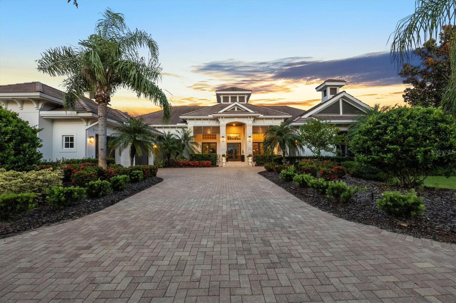 Welcome to 8009 Bounty Lane. A masterfully designed estate offering 4,484 square feet of refined living space, ideally positioned in one of Bradenton’s prestigious gated communities. This three-bedroom, 3.5-bath residence embodies a seamless blend of elegance, comfort and modern function, enhanced by a private pool, whole-house generator, and carefully selected upgrades throughout. From the moment you step through the grand entryway, soaring ceilings and expansive living areas set the tone for timeless sophistication. Architectural details and thoughtful finishes add warmth and character, while large windows bathe the home in natural light. The open floor plan encourages effortless flow, making it equally inviting for quiet relaxation or lively gatherings. At the heart of the home lies a chef’s kitchen designed to impress. Outfitted with premium appliances, custom cabinetry, a generous center island, and open sightlines to the main living and dining spaces, this kitchen is ideal for casual meals and upscale entertaining. The expansive primary suite serves as a private retreat, complete with a sitting area, spa-inspired bath, oversized walk-in shower, soaking tub, dual vanities, and a custom-designed walk-in closet. Two additional guest suites—each with its private bath—provide unmatched comfort and privacy for family and friends. Outdoor living is elevated to new heights with a spacious screened lanai, sparkling pool, and multiple lounging and dining areas. A fully fenced portion of the yard offers a secure haven for pets, while the whole-house generator ensures uninterrupted comfort year-round. Life at 8009 Bounty Lane extends well beyond the walls of the home. Residents of this sought-after community enjoy resort-style amenities including a beautifully appointed clubhouse, full fitness center, sauna, on-site restaurant, scenic parks, a basketball court, dog park, and a stunning resort-style pool, all within a secure, gated setting. Ideally just minutes from Lakewood Ranch, world-class golf courses, fine dining, boutique shopping, and the sugar-sand beaches of Florida’s Gulf Coast, this residence combines luxury living with everyday convenience. 8009 Bounty Lane is more than a home—it’s a lifestyle. A rare opportunity to own a residence where elegance, privacy and location converge in harmony.
