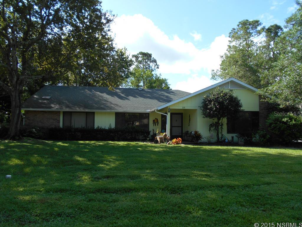 Sugar Mill Country Club Estates!  Golf, Community Pool, Clubhouse, and Entrance Security Guard.  This home features two living areas, vaulted ceilings, split bedroom plan, fireplace and screened porch. Best value in New Smyrna for a beautiful home on a beautiful lot in a gated country club community.  Both bathrooms are renovated yr 2016 ;Water: City