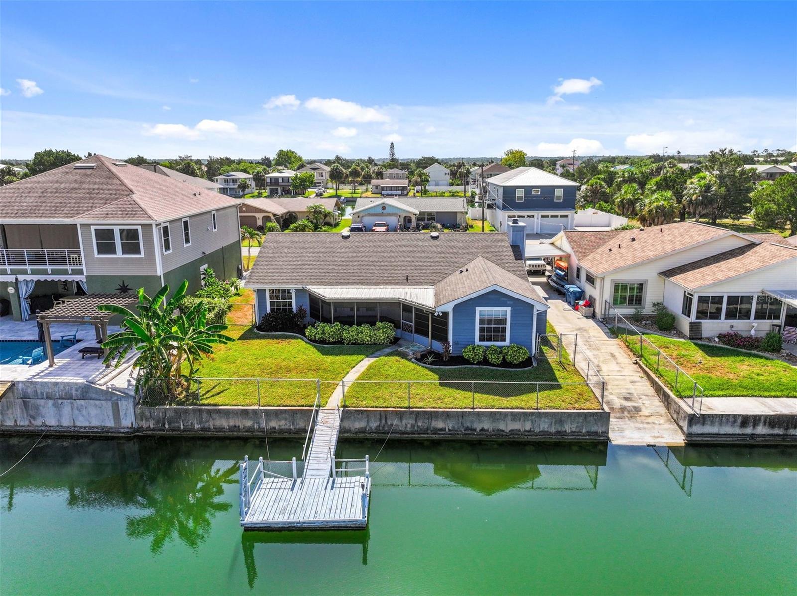 Coastal Living Meets Comfortable Waterfront Living in Hernando Beach!

Welcome to this beautifully designed 2-bedroom, 2-bathroom waterfront home where the open floor plan is centered around a stunning cook's kitchen—the true heart of the home. Whether you're preparing dinner for family or entertaining friends, you'll appreciate the quartz countertops, oversized center island, stainless steel appliances, white shaker cabinetry, and an abundance of storage.

The split-bedroom layout provides privacy for owners and guests, while luxury vinyl plank and ceramic tile flooring throughout make for easy coastal living. Step through the rear of the home to the large screened porch overlooking the peaceful freshwater canal, the perfect place to enjoy your morning coffee, evening sunsets, or watch Florida's native wildlife. The fenced backyard offers additional privacy and space for pets or outdoor entertaining.

Outside, you'll find 62 feet of concrete seawall and a floating dock on a spring-fed freshwater canal with indirect Gulf access. From your backyard you can launch your boat, kayak, or paddleboard and enjoy the waterfront lifestyle. Boaters can reach the Gulf of Mexico by using the community boat lift to cross into the saltwater canal system before passing under a fixed bridge, making this an excellent location for owners of smaller boats looking for affordable waterfront living.

Located in the desirable Hernando Beach Middle Section, this home offers all the advantages of waterfront ownership with no HOA. Short-term rentals are permitted, and owners have the freedom to keep boats, trailers, RVs, and commercial vehicles on their property while also being able to install up to 8-foot privacy fences.

Hernando Beach is one of Florida's hidden coastal treasures, where life revolves around boating, fishing, and enjoying the natural beauty of the Gulf Coast. Surrounded by protected coastal marshes and the Gulf of Mexico, the community features waterfront restaurants, tiki bars, marinas, seafood markets, and a relaxed Old Florida atmosphere.

Outdoor enthusiasts will love the incredible fishing opportunities for redfish, snook, trout, tarpon, grouper, and kingfish, while nearby offshore waters offer easy access to world-class fishing. The crystal-clear Weeki Wachee River is only minutes away for kayaking, paddleboarding, swimming, and enjoying its constant 74-degree spring-fed waters. Popular boating destinations such as the Hernando Beach Flats, Homosassa, Crystal River, and Anclote Key are all within easy reach by boat.

Although it feels like a secluded waterfront retreat, Hernando Beach is only about 10 minutes from US-19, offering convenient access to shopping, restaurants, Publix, Walmart, Sam's Club, medical facilities, and everyday conveniences. Tampa International Airport is approximately one hour away, with Orlando's attractions less than 90 minutes away.

Whether you're searching for a full-time residence, weekend getaway, vacation rental, or affordable waterfront retreat, this home offers the opportunity to embrace the Gulf Coast lifestyle in one of Florida's most unique boating communities. Come discover why so many people choose to call Hernando Beach home.