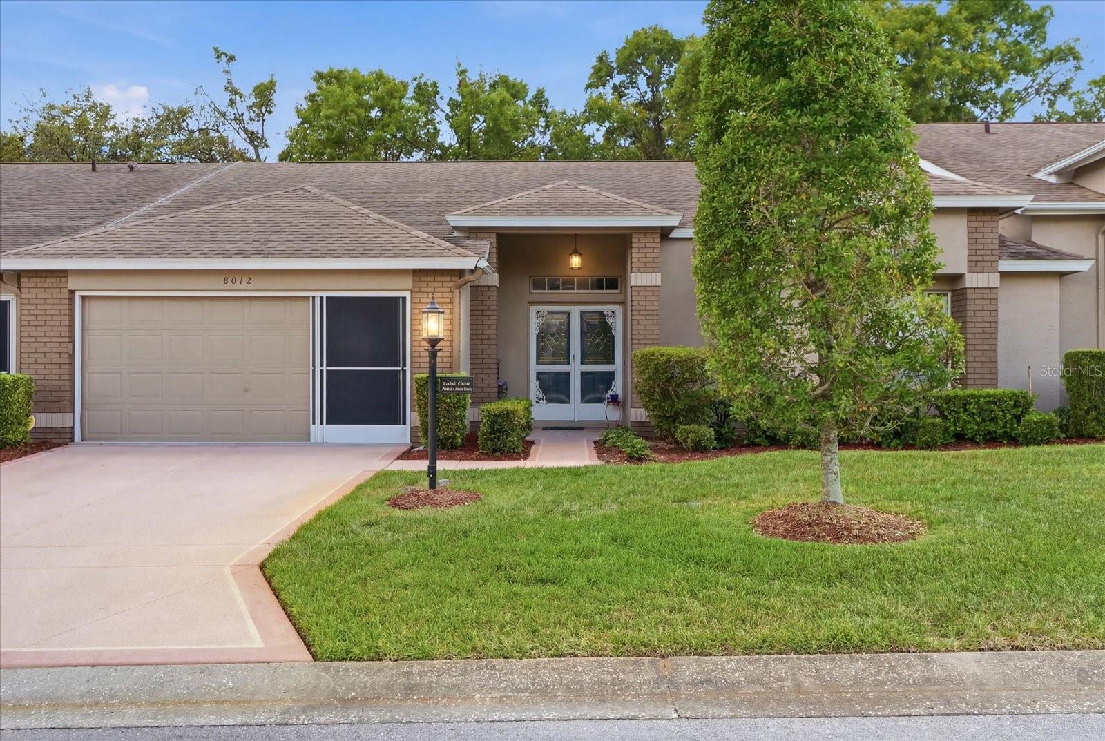 Welcome to carefree, resort-style living in the highly sought-after Timber Pines 55+ gated community!

This beautifully maintained villa offers an inviting open layout designed for both comfortable everyday living and effortless entertaining. Updated flooring flows throughout the kitchen and main living areas, creating a fresh and modern feel the moment you step inside through the elegant double front doors.

The spacious primary suite serves as a private retreat, featuring an ensuite bathroom with dual vanities and the rare convenience of two walk-in closets. The large living area seamlessly connects to sliding glass doors that open to a peaceful backyard setting where manicured landscaping, mature trees, and a tranquil nature view create the perfect place to relax and unwind.

Additional highlights include an interior laundry room with direct access to the oversized two-car garage complete with a screened enclosure, allowing you to enjoy fresh air while keeping pests out. 

Beyond the home itself, Timber Pines offers an unmatched lifestyle. This premier gated 55+ community features championship golf courses, swimming pools, fitness centers, pickleball and tennis courts, a performing arts center, on-site dining, and a vibrant social calendar filled with activities and events year-round.

Whether you're searching for a full-time residence or a seasonal escape, this is an exceptional opportunity to enjoy low-maintenance living in one of Hernando County's most desirable active adult communities. Roof was replaced in 2018 and the HVAC was replaced in 2016.