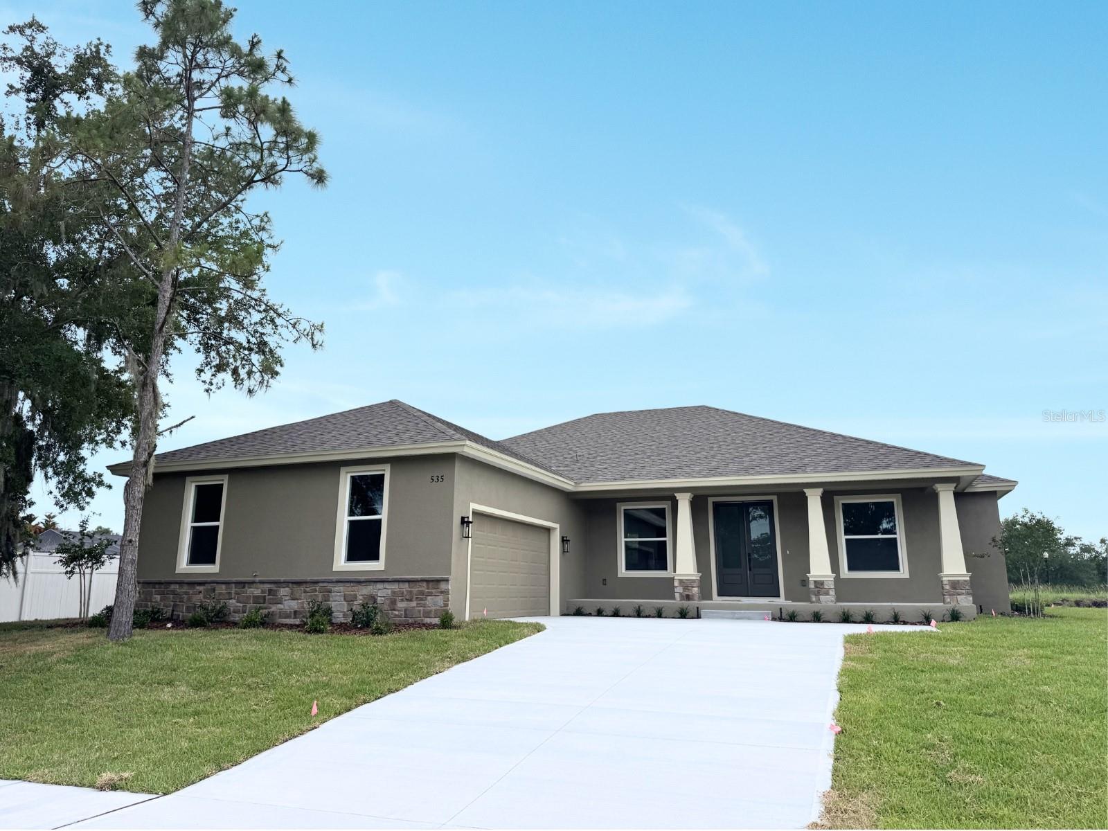 Under Construction. Check out this beautiful Brand-New Construction home FOR SALE located within a private and quiet gated community! This quality custom home is being built by a well-respected local home-builder with special attention to detail. Construction is finishing a few touches and will be completed very soon by the end of June 2026! 
Built with special attention to detail this home includes many upgrades, such as stone exterior accents, quartz countertops, upgraded trim, and custom woodwork. The spacious open floor plan features 4 bedrooms and 2.5 bathrooms 2,005 sq ft of living area with over 3,000 total under roof. The amazing great room concept, featuring tall ceilings seamlessly blends the kitchen, living, and dining areas - perfect for entertaining family and friends. The warm flooring and wood cabinetry adds a touch of elegance and coziness, making you feel right at home. The modern kitchen is the heart of the home and truly a chef's delight, complete with gorgeous cabinets, stone counters, tile backsplash, stainless appliances, a large island with bar seating, and an oversized walk-in pantry with ample storage. You are going to LOVE the size of this pantry! The gorgeous primary suite has a private, spa-like ensuite bathroom featuring an expansive modern shower with stunning tile, a dual vanity, a private toilet room, and spacious walk-in closet. Across the house are three guest bedrooms and a full bathroom. The mudroom from the garage into the home is fantastic, with an adjacent laundry room. The outdoor living here is fantastic! Enjoy sitting in the shade from your covered back porch. 
This home is NOT in a flood zone (Zone X), so NO FLOOD insurance is required. The location is great! Dining and shopping are just minutes away in charming Downtown Bartow. You will also appreciate the convenience between Tampa and Orlando. It is only 50 miles to Walt Disney World, 65 miles to Orlando Airport, 48 miles to Tampa Airport, and less than an hour and a half to several Florida beaches. So many outstanding features about this lovely home! 
This home is JUST what you have been looking for! Your new home awaits you! 
Don’t wait months to build – this one is ready!! Call today for more details and to set up your private showing.
*The builder is offering Interest Rate Buy Down / Closing Cost Assistance with their preferred lender - Jamie Brown, Plains Commerce Mortgage!!*

NOTE - More photos will be uploaded as soon as the interior is completed!