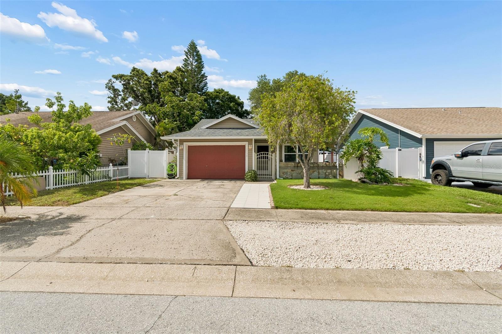 Secluded cul-de-sac living in the desirable Tall Pines Estates community of Largo. The low-maintenance landscaped front yard, complete with front and rear irrigation, creates inviting curb appeal. Step through the front gate to a spacious covered patio that wraps from the front of the home to the backyard, creating the perfect space for relaxing, entertaining, or enjoying Florida living year-round. The fully vinyl-fenced backyard offers plenty of room for a future pool, a dog run, or simply a private green space to unwind. Inside, vaulted ceilings and an open-concept layout make the home feel bright and spacious. Natural light pours through hurricane impact windows and a hurricane impact sliding glass door, all installed in 2024, providing peace of mind while enhancing the home’s inviting atmosphere. The kitchen serves as the heart of the home with stainless steel appliances, a breakfast nook, and a breakfast bar that opens to the living area, perfect for everyday living and entertaining. A full guest bathroom, complete with a tub and linen closet, is conveniently located off the main living space. The spacious primary suite overlooks the backyard and offers a peaceful retreat with room for a king-size bed, a large walk-in closet, and a private en-suite bathroom with a walk-in shower. The generously sized second bedroom also accommodates a king-size bed and features two closets for exceptional storage. A dedicated laundry area is located in the oversized 15’ x 20’ one-car garage. Additional highlights include a 2023 HVAC system, a 2018 shingle roof, and a location outside of a flood zone. Zoned for Largo Middle and Largo High School, both of which offer International Baccalaureate (IB) programs. Just four miles away, Largo Central Park hosts some of the area’s most popular community events, including the Fourth of July Celebration, Memorial Day Ceremony, and the Holiday Lights & Carnival Stroll featuring more than two million LED lights. Residents also enjoy recurring favorites like the free Largo Central Railroad Train Weekend and Movies in the Park.