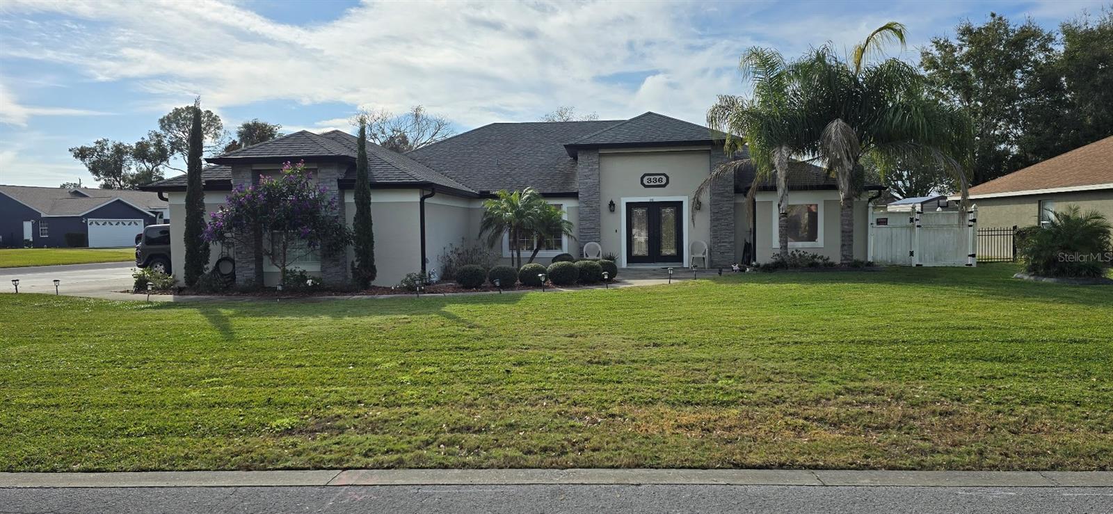 You won’t want to miss this stunning custom home, where thoughtful upgrades and move-in-ready convenience come together beautifully. This 3-bedroom, 2.5-bathroom residence offers the perfect blend of comfort, functionality, and style. At the heart of the home is a gorgeous kitchen designed to impress, featuring rich real wood, soft-close cabinetry, granite countertops, and a massive island—perfect for cooking, gathering, and entertaining. Relax year-round in the well-insulated Florida room, or host unforgettable get-togethers on the expansive 60' x 30' enclosed porch, complete with built-in cabinetry, an outdoor sink, and its own half bath—ideal for effortless indoor-outdoor living. The spacious primary suite is your personal retreat, offering a luxurious bathroom with a soaking jacuzzi tub, a large walk-in shower, and plenty of room to unwind. Enjoy peace of mind knowing the roof and HVAC were both replaced in 2018. Bring all your toys and hobbies—this property features an oversized 3-car attached garage plus an additional detached garage for extra storage or workspace. Step outside to a fully fenced backyard where you can enjoy fresh fruit from your own mango, avocado, peach, and lime trees. Located just minutes from beautiful lakes, scenic parks, shopping, and a variety of local restaurants, this home offers not only incredible features but also a convenient and vibrant lifestyle. This home truly has it all—schedule your showing today!