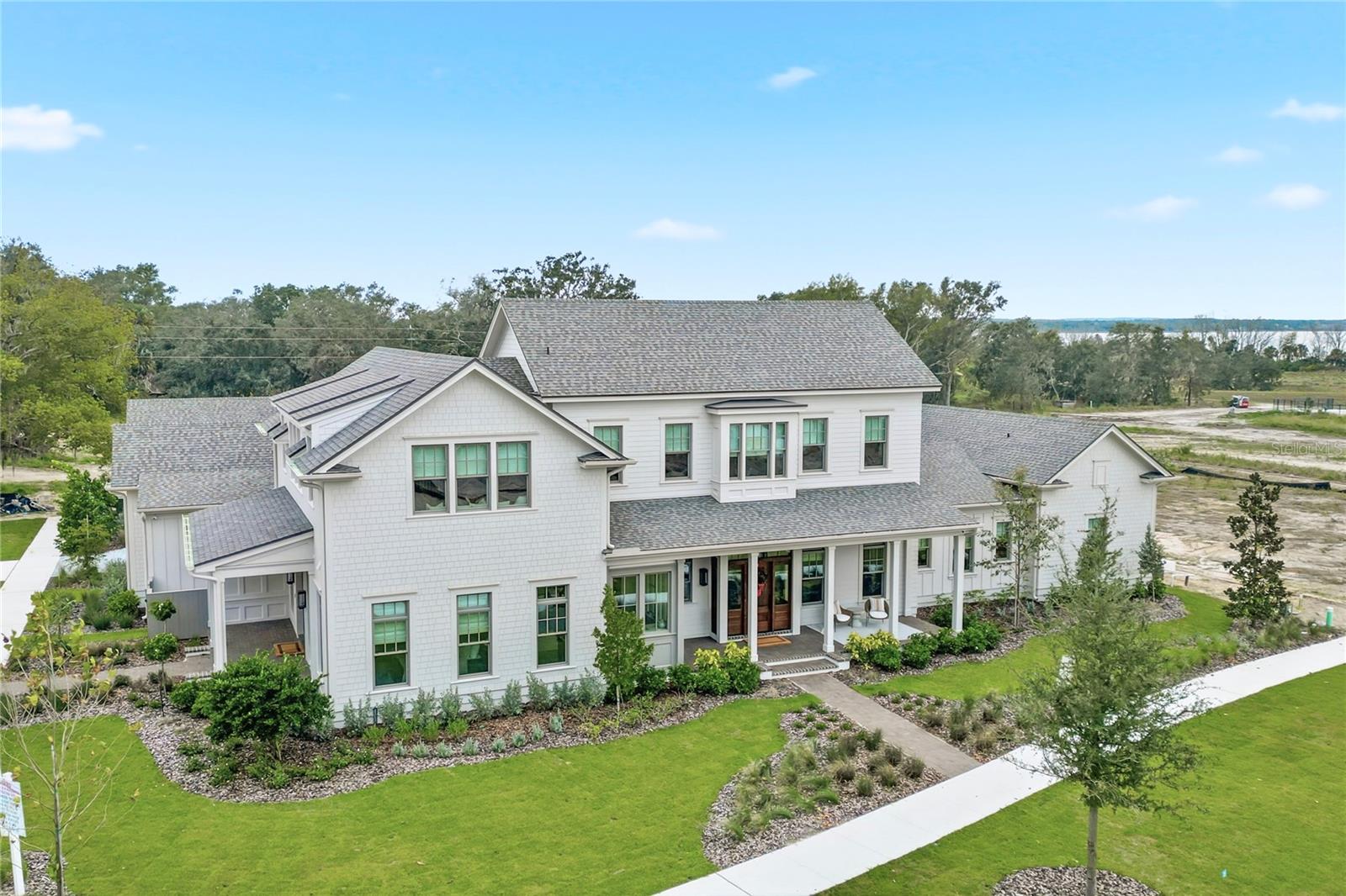 Stunning J&J Model Home in Briley Farm – Leaseback Opportunity! Step into unmatched luxury at this impeccably crafted J&J Building model home, perfectly positioned on a premier corner lot in the sought-after Briley Farm community of Oakland, FL. Designed with exceptional attention to detail, this residence offers 4 bedrooms, 4 full baths, 2 powder baths, a loft, bonus room, private office, two laundry rooms, and a detached casita with a full ensuite—ideal for guests, in-laws, or extended stays. Inside, the home showcases elevated finishes at every turn, including Sierra Pacific windows—62 in total—filling the home with natural light, an impressive Euro-style 9'+ bifold slider, and a stunning gas fireplace anchoring the main living space. The chef’s kitchen boasts Wolf and Sub-Zero appliances, exquisite Quartzite counters in both the main and back kitchens, and a fully equipped back kitchen designed for effortless entertaining. A custom primary closet with lighted rods adds a boutique touch to everyday living. Outdoor living is equally exceptional. Enjoy a lap pool and hot tub, gas fire pit, and luxurious marble coping and pool decking, all beautifully framed by a $70,000 professionally designed landscaping package and a fully fenced yard for privacy. Additional upgrades include Sonos speakers, security system with cameras, clay tumbled pavers on the porches, and a Generac generator for added comfort and peace of mind. With a 4-car garage, impeccable craftsmanship, and a leaseback opportunity, this home offers the best of luxury and convenience. Furniture is negotiable, allowing you to tailor the space to your vision. Discover refined living in one of Oakland’s most desirable communities—this model home truly sets the standard.