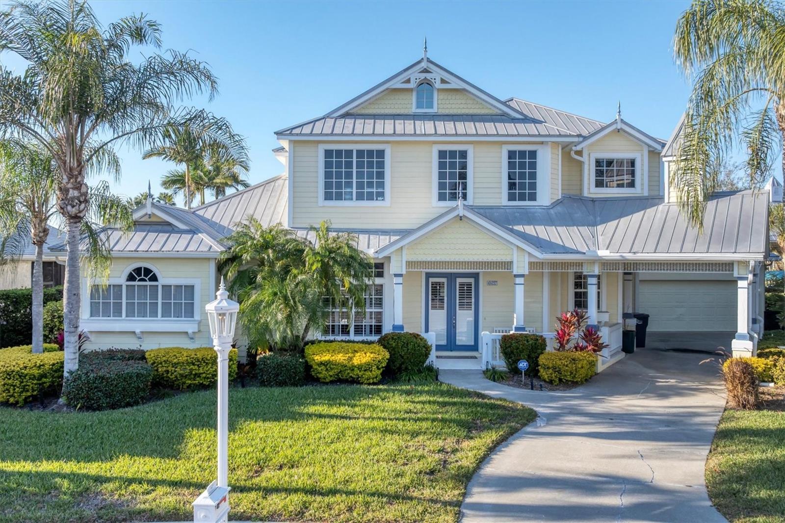 Step into a piece of music history with this stunning Key West-style retreat, formerly the private residence of Graeme Edge, legendary drummer and founding member of the Moody Blues!  Nestled on a deep-water, 123 foot canal boasting direct access to the Manatee River, this estate offers a lifestyle that is both soulful and sophisticated.  Situated at the end of a cul-de-sac street, this home's classic Key West aesthetic is highlighted by a durable metal roof and expansive, very open living space totaling just under 3100 square feet.  At the heart of the home, a beautifully remodeled chef's kitchen with double oven serves as the perfect centerpiece for entertaining.  With four spacious bedrooms and 3.5 baths, there is ample room for family and guests.  The primary bedroom is on the first floor and the upstairs features a 15'x28' loft with adjacent bedrooms.  A downstairs bonus/game room makes this house beyond perfect for entertaining and leisure.  Outside, your private tropical oasis awaits featuring an outdoor shower, and a sparkling heated pool/spa overlooking the water.  Hop on your boat for a sunset cruise on the Manatee River or simply enjoy the peace and serenity of the waters.  Recently painted in wonderful soft colors, this home truly has it all.  Whether you are a boating enthusiast or a seeker of serene sunsets, this home is a "Nights in White Satin" dream come true.  This home is in an very low HOA community and NO CDD!!!!!  Schedule your showing today!