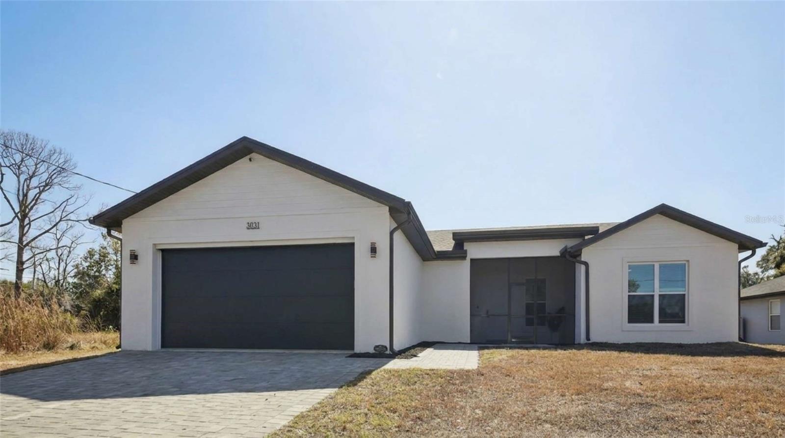 WOW! What a beauty. You won't believe until you see it for yourself. This newly constructed, masonry home was built for comfort and convenience. The open design provides the perfect atmosphere for entertaining or relaxing in style. You'll love the stunning waterfall quartz island, upgraded appliances that the kitchen has to. Enjoy the casual egress into the main living area, featuring a built-in media wall. The master suite's walk-in shower will make you think you went on a spa retreat. This carefully engineered home was custom built for efficiency, durability and quality of life. It includes PGT impact windows, and closed lanai, spray form attic insulation and insulated two car garage with a dedicated A/C system.