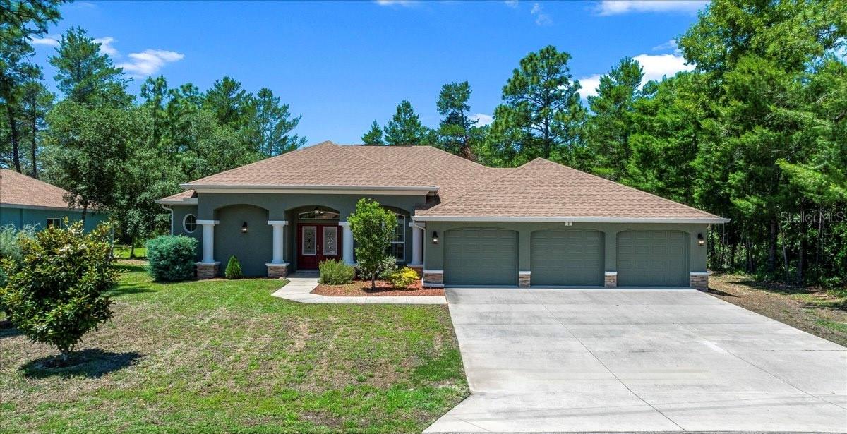 Perfectly positioned in the highly desirable Oak Village section of Sugarmill Woods, this beautifully maintained 2021 built pool home offers the ideal blend of modern design, everyday comfort, and peaceful Florida living. Featuring 3 bedrooms, 2 baths, and 1,992 Sq.Ft. of living space, this move in ready home welcomes you with an inviting open layout, abundant natural light, and a thoughtfully designed split bedroom floor plan. The spacious kitchen offers granite countertops, stainless steel appliances, rich wood cabinetry, tile flooring, and a sunny breakfast nook perfect for enjoying your morning coffee. Oversized primary suite serves as a relaxing private retreat with sliding glass doors leading directly to the pool area, dual walk in closets, and a spacious ensuite bathroom featuring dual vanities and a tile walk in shower. The additional bedrooms offer flexibility for guests, family, or a home office, while the guest bathroom also includes direct access to the pool area for added convenience. Designed with functionality in mind, this property also features a spacious 3 car garage with oversized 9 foot wide doors, attic storage for added organization, and thoughtful details throughout. Step outside and enjoy the beautifully designed screened pool area completed in 2026, perfect for entertaining, unwinding, or enjoying Florida’s year round outdoor lifestyle while overlooking the peaceful private backyard setting. Situated on a private 0.28 acre lot with a peaceful greenbelt backdrop, the backyard offers added privacy and plenty of room to relax, entertain, or create your own outdoor oasis. Beyond the home itself, residents of Sugarmill Woods enjoy a beautifully maintained deed restricted community known for its scenic greenbelt privacy, mature landscaping, and peaceful Nature Coast setting. Optional community amenities include golf courses, tennis and pickleball courts, fitness facilities, a junior Olympic sized pool, clubhouse dining, and social activities through the nearby Sugarmill Woods Country Club and Oak Village Sports Complex. Conveniently located near shopping, dining, boating, fishing, and the Suncoast Parkway for easy access to Tampa, this home offers the perfect balance of tranquility and convenience. Schedule to tour this gorgeous home before it’s too late!