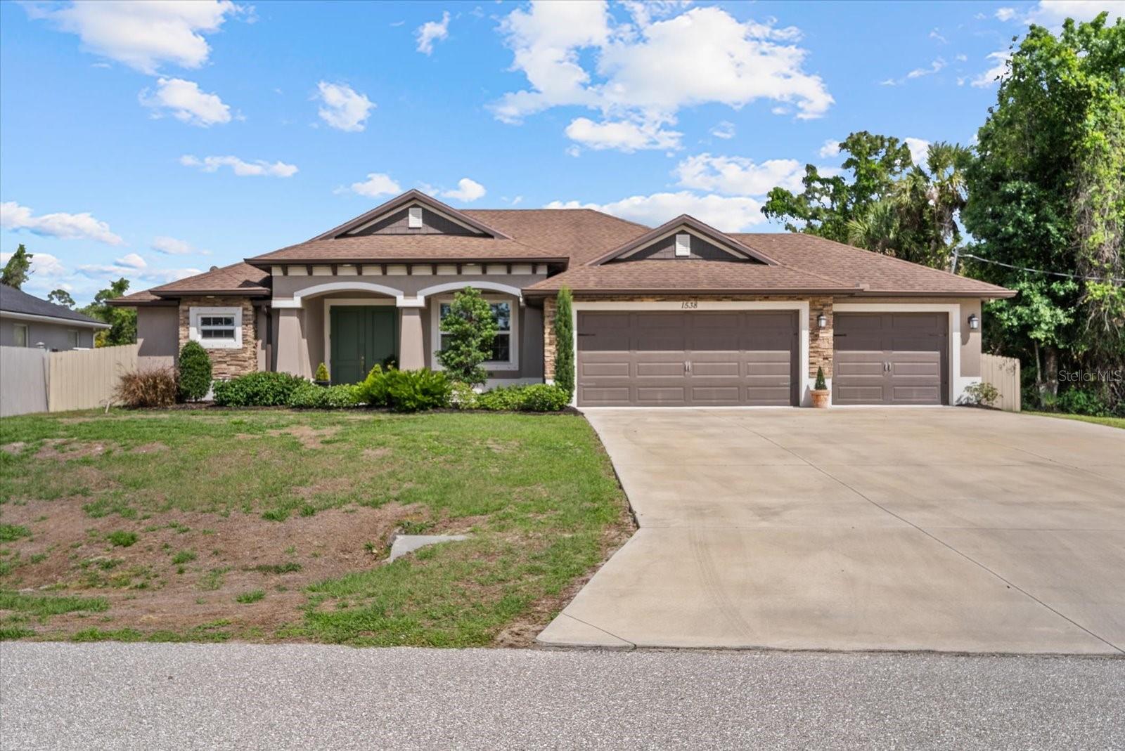 Welcome to this beautifully appointed Zwiercan Homes residence, offering nearly 2,000 square feet of thoughtfully designed living space in a desirable North Port location. Created for both everyday living and entertaining, this 3-bedroom, 2-bath floor plan combines style, comfort, and functionality throughout. The open living area is enhanced by soaring tray ceilings, crown molding, and French doors that lead to an oversized patio with room for a pool. The private owner’s suite is situated on one side of the home and offers two walk-in closets,  along with a spacious, spa-like en suite, and a transom window that fills the room with soft natural light.
The chef’s kitchen is appointed with granite countertops, a tiled backsplash, and stainless steel appliances. Guest bedrooms and the secondary bath are positioned with a private entry off the kitchen, and the bath includes a walk-in shower for added accessibility. Situated on a spacious homesite with no deed restrictions and adjacent to vacant lots on the side and rear, the property offers exceptional privacy and flexibility. The exterior features upgraded landscaping, additional driveway space, a fully fenced perimeter, and a large three-car garage. An advanced water filtration system adds another layer of comfort and convenience.
With its thoughtful layout, upgraded finishes, and prime location, this home is a standout opportunity in North Port. Schedule your private showing today!