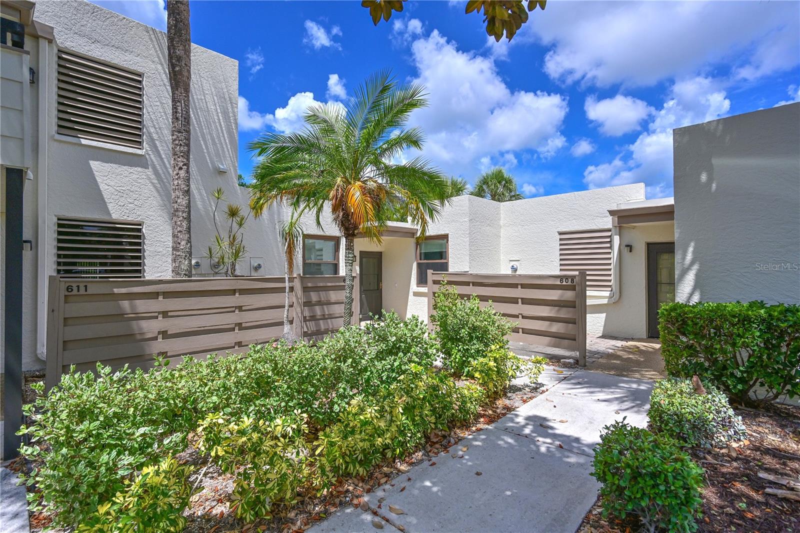 WOW! Welcome to one of the most unique and beautifully updated villas in Wildewood Springs. Tucked inside this lush, tropical, park like community, this move in ready home offers the peaceful Florida lifestyle buyers dream about. Surrounded by towering palms, mature trees, lakes, and walking paths, Wildewood Springs is known for its quiet natural beauty and active lifestyle. Residents love to walk, jog, bike, swim, play tennis and pickleball, and simply enjoy the serenity of this incredible 88 acre Audubon bird and wildlife sanctuary.
Lovingly restored and refreshed, this villa has been thoughtfully improved throughout with new pavers, scraped and resurfaced ceilings, fresh wall to wall paint, updated interior doors and handles, electrical updates, refreshed courtyard walls, a new storm door and locks, rescreened lanai windows, new water heater, and a brand new Ruud 3 ton AC system installed in 2023. The interior laundry room adds everyday convenience, while parking sits just outside your front door.
One of the standout features and something rarely available in Wildewood Springs is the incredible private courtyard. This peaceful outdoor oasis creates the perfect space for morning coffee, entertaining friends, gardening, or simply enjoying the beautiful Florida weather year round. Just outside the courtyard gate is a secluded lake, adding even more to the tranquil setting.
Inside, the spacious layout flows beautifully, while the enclosed Florida room adds approximately 300 additional square feet of versatile living space not currently under air, bringing the total footprint to nearly 1,800 square feet. Many owners choose to remove the sliders to seamlessly incorporate this space into the main living area, creating an even more spacious and open feel throughout the home.
This villa truly offers the best of Florida living. Clean, updated, spacious, private, and surrounded by nature while still being just a short 15 minute drive to the stunning Gulf beaches of Anna Maria Island and the cultural attractions, dining, shopping, and entertainment of Sarasota.
There are very few opportunities to own a courtyard villa in this highly sought after community. Move right in, make it your own, and start enjoying everything this special home and neighborhood have waiting for you.