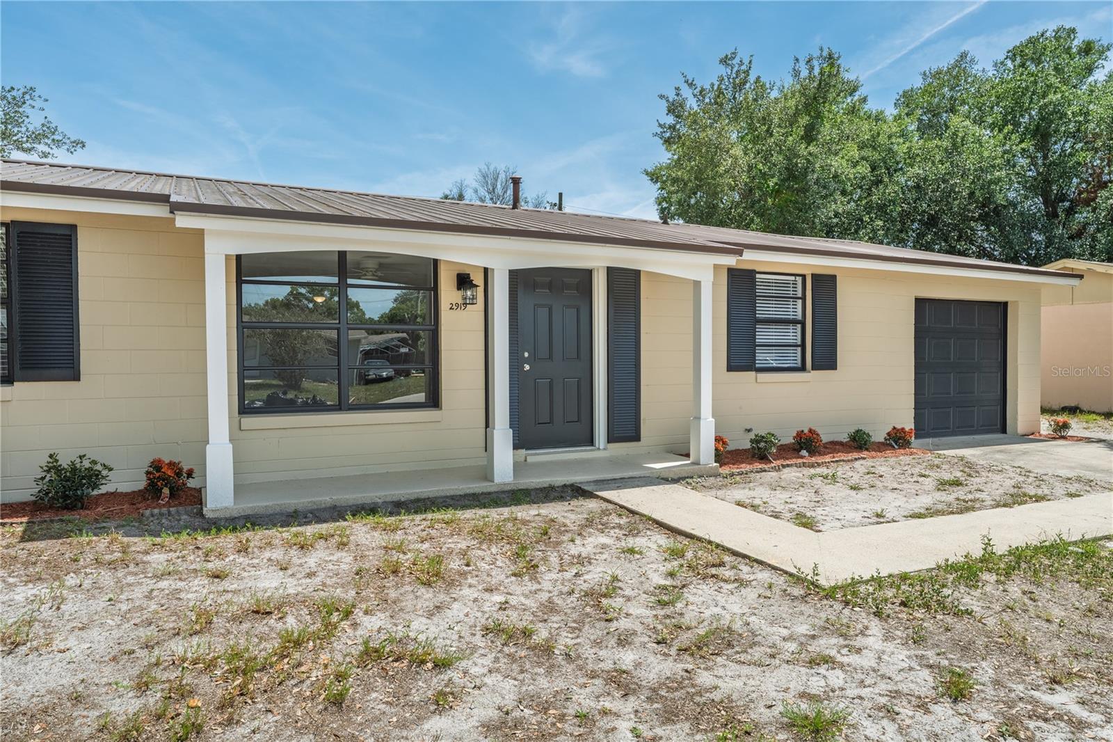 Beautifully renovated from top to bottom, this move-in ready 3-bedroom, 2-bathroom home in the heart of Deltona offers the perfect blend of style, comfort, and convenience. Ideally located just minutes from major roads, schools, Publix, and Lowe's, this home provides easy access to everyday essentials while maintaining a peaceful residential setting.

Step inside to discover fresh, modern updates throughout, including new interior paint, durable wood-look luxury vinyl flooring, updated lighting, and a bright, open layout. The beautifully redesigned kitchen features timeless shaker cabinetry, sleek countertops, and brand-new stainless steel appliances, creating a stylish and functional space for cooking and gathering.

Just off the kitchen, a convenient mudroom and utility area provide additional storage and functionality, with access to the freshly painted one-car garage and dedicated washer and dryer space.

Both bathrooms have been tastefully updated with new tile, modern vanities, updated lighting, and full-size tubs. The spacious primary suite offers a relaxing retreat complete with a large walk-in closet. The thoughtfully designed split-bedroom layout provides privacy, and the rear bedroom features its own private exterior entrance, offering flexibility for guests, a home office, or multigenerational living.

Outside, the improvements continue with fresh exterior paint, updated landscaping, fencing on three sides of the property, and a durable metal roof for long-term peace of mind.

This beautifully updated home is truly move-in ready—schedule your private showing today!