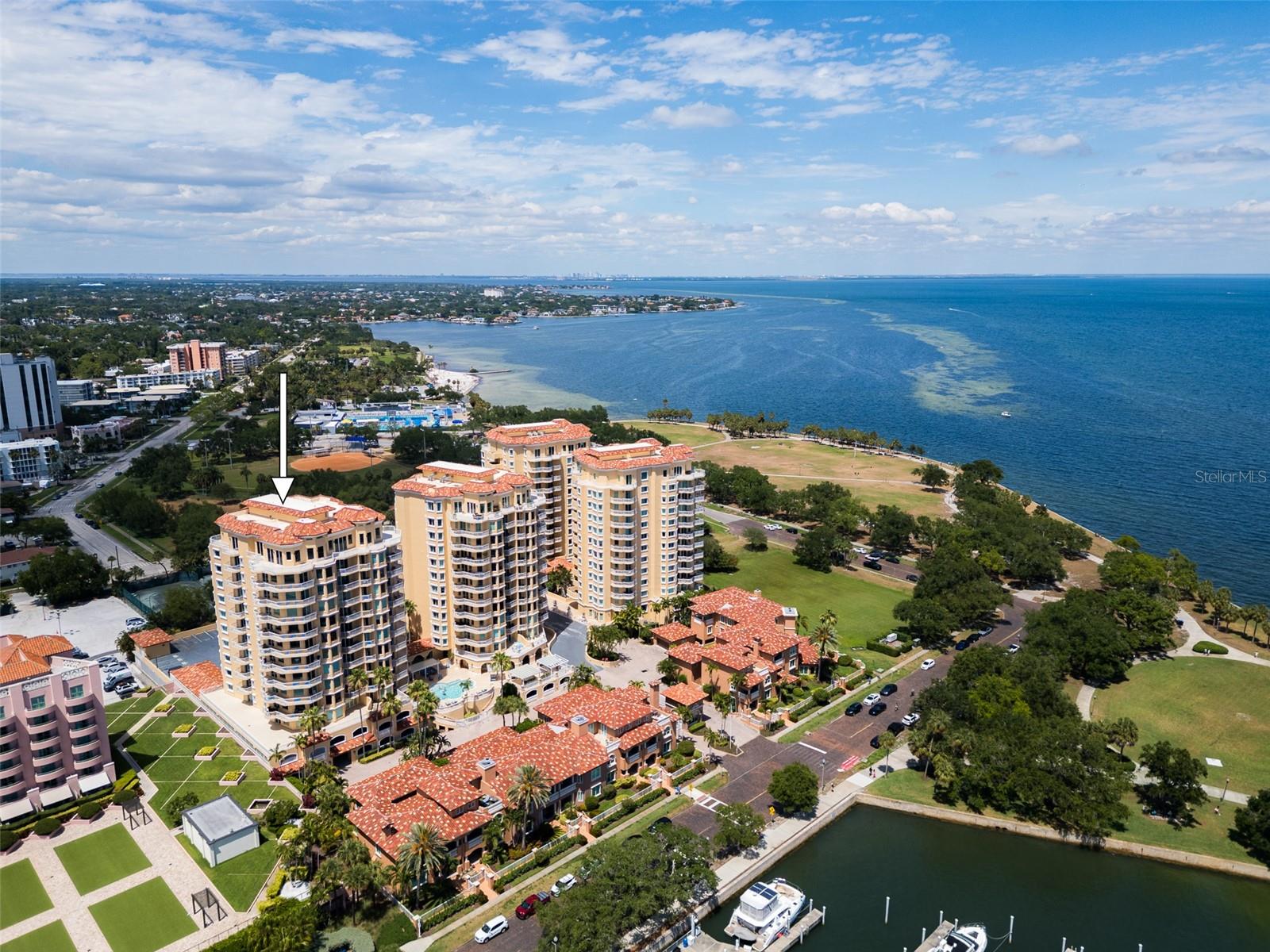 One or more photo(s) has been virtually staged. WATERFRONT LIVING AT ITS FINEST-Welcome to Vinoy Place—an exclusive, 24-hour gated waterfront enclave where timeless Palm Beach–inspired Mediterranean architecture meets refined, resort-style living. This exceptional 3,300-square-foot residence offers breathtaking panoramic water and skyline views, expansive terraces, and the rare distinction of a private elevator entry. The ideal elevation of Unit 711 offers a truly unique vantage point—perfectly positioned so your gaze extends straight out across the horizon rather than downward. From this height, enjoy sweeping views that capture the iconic Sunshine Skyway Bridge in the distance, while still taking in the vibrant life below, from people strolling along the streets to dolphins playing in the water. This spacious three-bedroom, two-and-a-half-bath floorplan with wider rooms, enhanced window lines, and extended decks, is designed for those who value openness, privacy, and elegance. From the moment you step off the semi-private elevator into your personal foyer, the experience is unmistakable—this is more than a residence; it is a statement. Dramatic floor-to-ceiling windows frame unobstructed waterfront vistas, filling the home with natural light and seamlessly blending indoor and outdoor living. Expansive, oversized terraces provide the perfect setting for unforgettable sunrises, glowing sunsets, and evenings overlooking the city skyline. A flexible Vinoy Room serves beautifully as a private office, media room, or serene retreat. The chef’s kitchen is equally impressive—designed for both function and entertaining with high-end appliances, custom cabinetry, and generous workspace, all complemented by stunning water views. Wood flooring enhances the main living areas, while plush carpeting brings warmth and comfort to the bedrooms. A thoughtfully designed guest room with a Murphy bed offers stylish flexibility without sacrifice. Refined upgrades throughout include electric shades, custom finishes, designer paint treatments, stone countertops, premium fixtures, a reverse osmosis filtration system for both the kitchen and refrigerator, and a whole-home water softening system for optimal water quality and everyday comfort. Adding to its rarity and convenience, this residence includes: Two premium covered parking spaces on the lobby level, each equipped with electrical outlets, standard storage, plus an exclusive 220-square-foot air-conditioned private storage room—one of only two in the entire community. Residents enjoy resort-style amenities, including: 24-hour gated security, two sparkling pools with spas, a well-equipped outdoor kitchen, a state-of-the-art fitness center, club and entertaining rooms, a billiards room, and beautifully appointed social spaces. Adjacent to the iconic The Vinoy Resort & Golf Club, a historic and luxurious waterfront landmark in downtown St. Peterburg-Vinoy Place is a distinguished residential enclave that stands apart from newer developments by offering what simply cannot be replicated: timeless architecture, an irreplaceable waterfront setting, generous space, privacy, and a premier location. Just steps from fine dining, shopping, marinas, waterfront parks, and cultural venues, the residence also boasts exceptional walkability allowing you to effortlessly enjoy the very best of the city without ever needing to drive. Vibrant downtown living is truly at your doorstep. This is luxury living without concession.  Private showings available by appointment.
