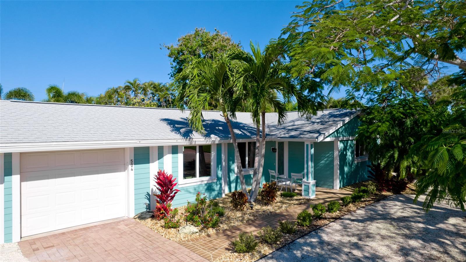 This newly remodeled open floor plan Anna Maria Island Hideaway is nestled in the heart of the island in Holmes Beach just off of Marina Drive. Just 4 blocks to the award winning white sandy beaches of Anna Maria. With this home you will enjoy a comparatively large and spacious floor plan and a “old Florida” feel of the quiet neighborhood along with the benefit of the totally private back yard and gorgeous marina water views from the front. This home has large hurricane-rated windows with Levolor Custom Sheer Shade window coverings, new ceramic tile flooring throughout, a beautifully revamped kitchen with new GE stainless steel appliances, a separate indoor laundry room with new GE large capacity front load washer/dryer and plenty of additional cupboard storage, and newly tiled spa-like bathrooms. Comfort is assured at all times with a brand-new Carrier A/C with heat pump and smart home thermostat and a tankless water heater for never-ending hot showers. The backyard is a private tropical oasis featuring an updated and heated saltwater pool with new pump, pool heater and salt chlorinator, a top of the line 2022 HotSprings Vanguard saltwater hot tub, lush irrigated and lighted landscaping, a 6ft privacy fence surround, and a massive fan cooled and lighted tiki-covered paver patio for outdoor TV and entertaining. The home exterior has updated HardiePlank siding, a 2019 roof, and beautifully landscaped yard along with the marina canal views right across the street. Just a short 4 block walk to the Gulf beaches and close to everything that makes Anna Maria Island great: top restaurants and pubs, free Island Trolley, boutiques, and all the beach and cart-riding fun you can handle to provide the ultimate island living experience. Finally, and very importantly, this home has no HOA, no Master Association, no CDD fees, and can be (is currently) Homesteaded to keep property taxes manageable.